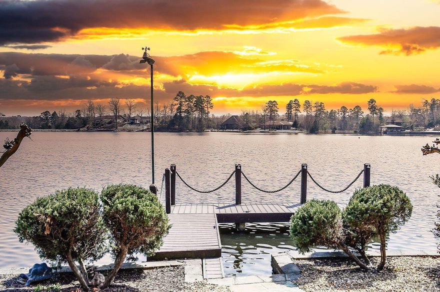 Lakefront luxury on Lake Sophia! This Renaissance-built home showcases classic French European architecture with 4 bedrooms and 4.5 baths, each bedroom featuring a private en-suite bath for added comfort and privacy. The open-concept central kitchen is ideal for entertaining and is complemented by a spacious Butler’s Pantry for additional prep and storage. Interior highlights include a dedicated media room, a built-in office, and a FEMA-approved safe room. Step outside to enjoy covered patios, decks and a brand new flagstone patio, outdoor fireplace, and a peaceful water feature—all designed for year-round outdoor living. The property offers 174 feet of seawall with a private dock, making it perfect for lakefront enjoyment, boating, and relaxing water views. There is audio and video surveillance on the exterior of the property. Interior photos coming April 1st. Call now for your private VIP showing. See Associated Docs for full features list.