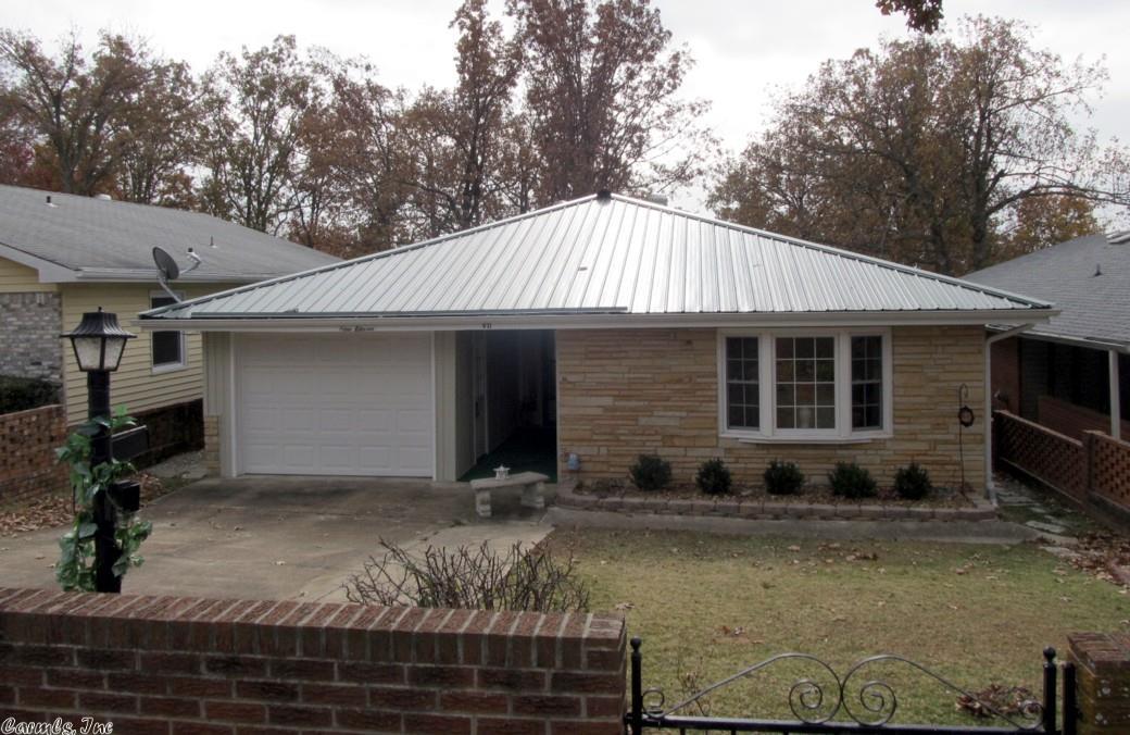 Beautiful Manor Home with Garage. This manor home offer 2 bedrooms, 1-3/4 baths, spacious living room, updated kitchen, heat pump, gas log fireplace, utility room, remodeled master bath with walk-in shower, metal roof (2010), covered back patio overlooking the clubhouse and swimming pool. Also has a garage!
