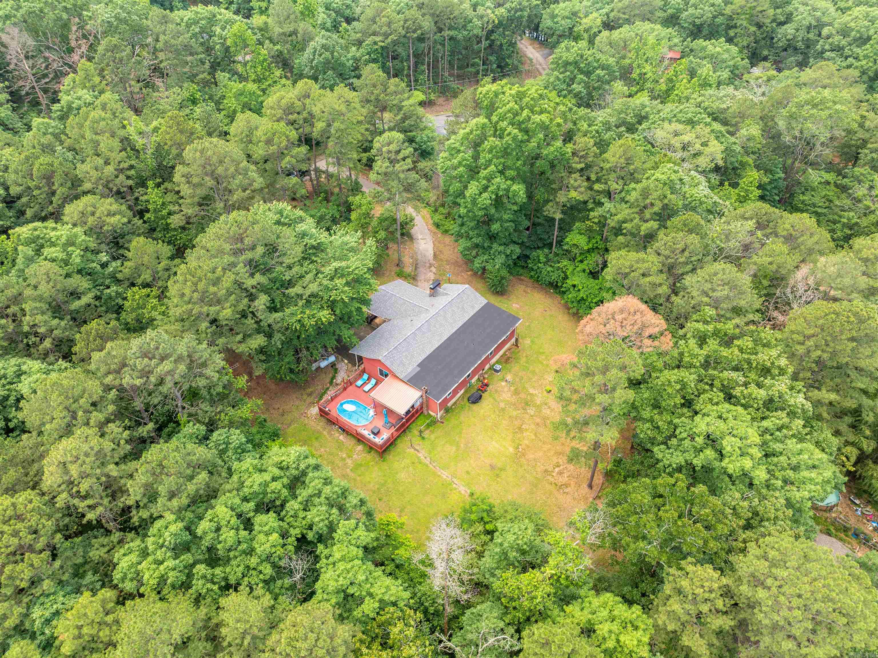 If privacy and seclusion are what you're looking for, this 3-bedroom, 2.5-bath home on 5.47 acres at the end of a dead-end road is a must-see. Nestled in a peaceful setting with a small pond, this property offers space, comfort, and thoughtful updates throughout. Inside, you'll find an updated kitchen with granite countertops and modern bathrooms. The living room features a cozy wood-burning fireplace, while the bonus room includes a gas log fireplace for added warmth and charm. The third bedroom, equipped with a Murphy bed that conveys, offers flexible use as an office, guest room, or hobby space. Step outside to enjoy the above-ground saltwater pool with a surrounding deck—perfect for unwinding or entertaining. Additional features include a Generac whole house generator, new roof and HVAC system installed in 2024, plus two storage sheds (10x12 and 3x5) for your tools and equipment. This property combines seclusion, modern updates, and plenty of space to spread out—while still being conveniently close to amenities.