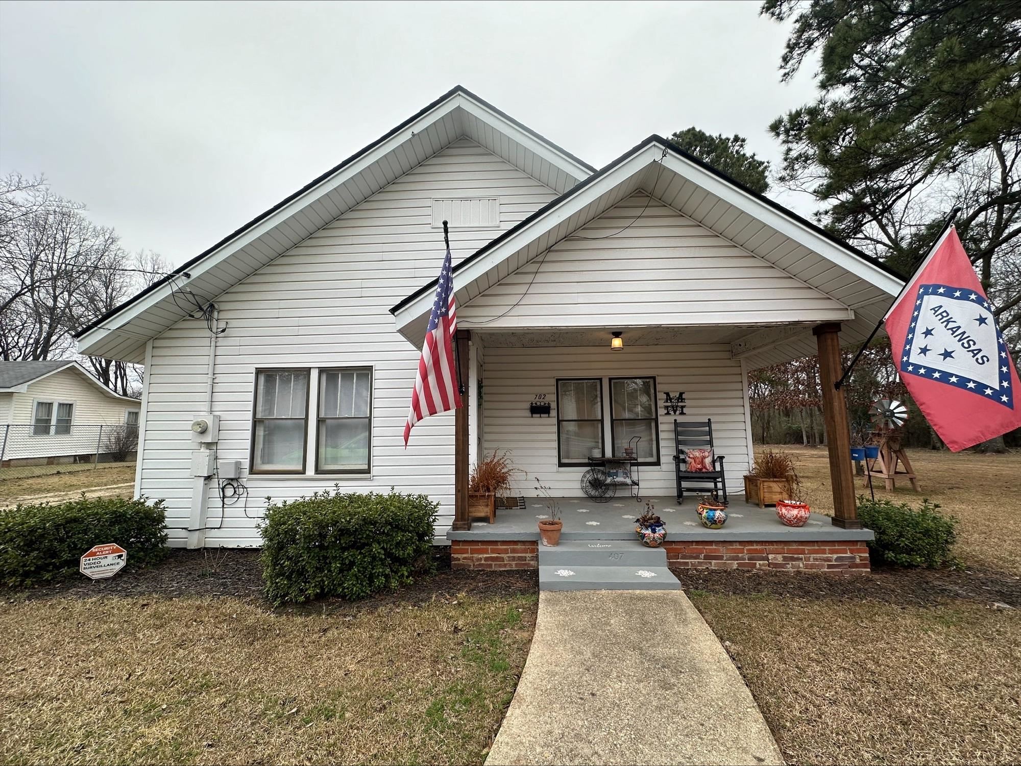Step into this beautifully remodeled traditional southern home and you just may never want to leave. The gorgeous pine floor greets you at the front door and the historic wooden walls and bathroom ceiling, that was found under the old cheesecloth wall paper, was left as a nod to the home's history. This home checks a lot of boxes, with 3 bedrooms, 2 baths, a carport, workshop, storm shelter and a recent remodel including a new roof, new paint, flooring and fixtures through out and new tankless water heaters. The bathroom updates are serene, with a shower in the primary bedroom and a clawfoot tub between the two guest rooms. The kitchen remodel includes updated smart appliances, counter tops, backsplash and refaced, repainted cabinets, not much is left to do other than walk out your bedroom door, to the new deck, and relax and unwind.