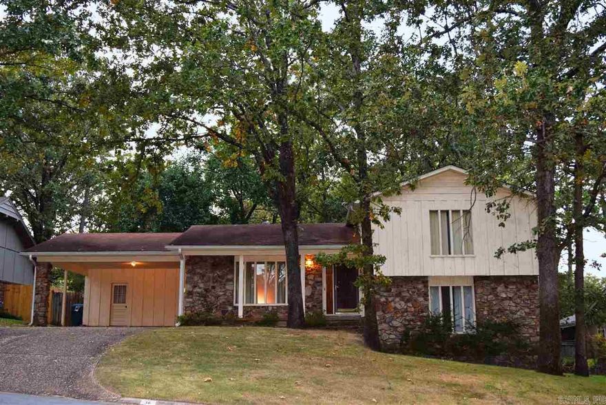 Good looking rock & cedar in Colony West on a quiet street - this home is a must see jewel! Many updates include: freshly painted interior, brand NEW carpet, & a new metal carport door. Nice floor plan w/ formal living rm, large eat-in kitchen, lovely den w/ rock WBFP, wet bar, wood beams & access to lower deck. Guest BR down w/ full bath. HUGE master BR w/ large closet & dbl doors to 2nd level deck overlooking park-like backyard. Outside storage rm & storage shed. Fully fenced backyard. Sep laundry area.