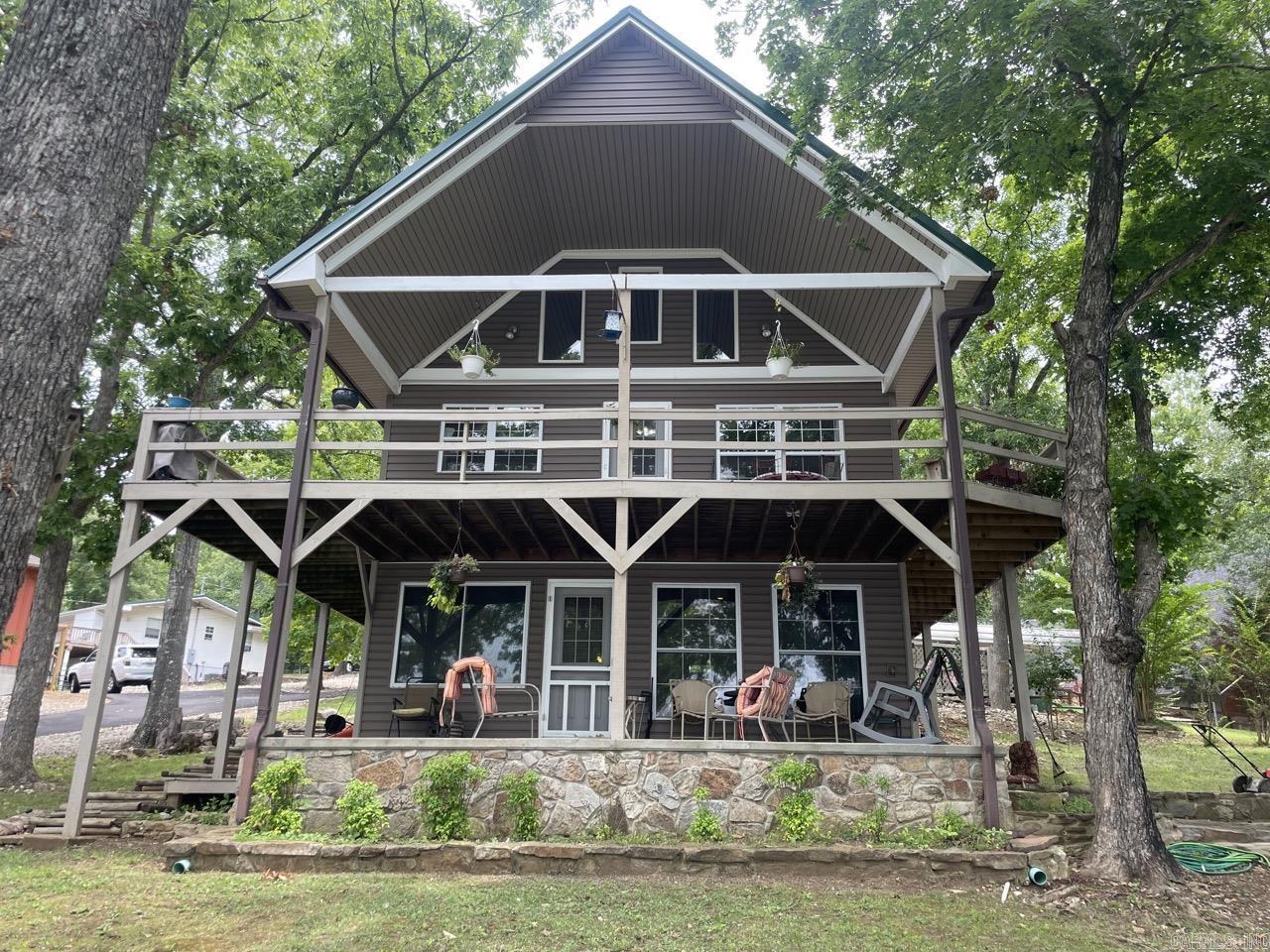 PRICE IMPROVEMENT! Welcome to your dream lake house in Hardy, Arkansas where this tri-level home offers amazing views of private Lake Sherwood. With 4 bedrooms and 2.5 baths, this residence offers tons of comfort, privacy, and relaxation. This property provides easy access to fishing, boating, and other water activities. Multiple living areas throughout the home provide plenty of space for family gatherings, complete with picturesque lake views. Whether you're seeking a weekend getaway or a year-round residence, this property is sure to exceed your expectations. 160 feet of shoreline! Schedule your private tour today and envision life near the Spring River! Agents see remarks.