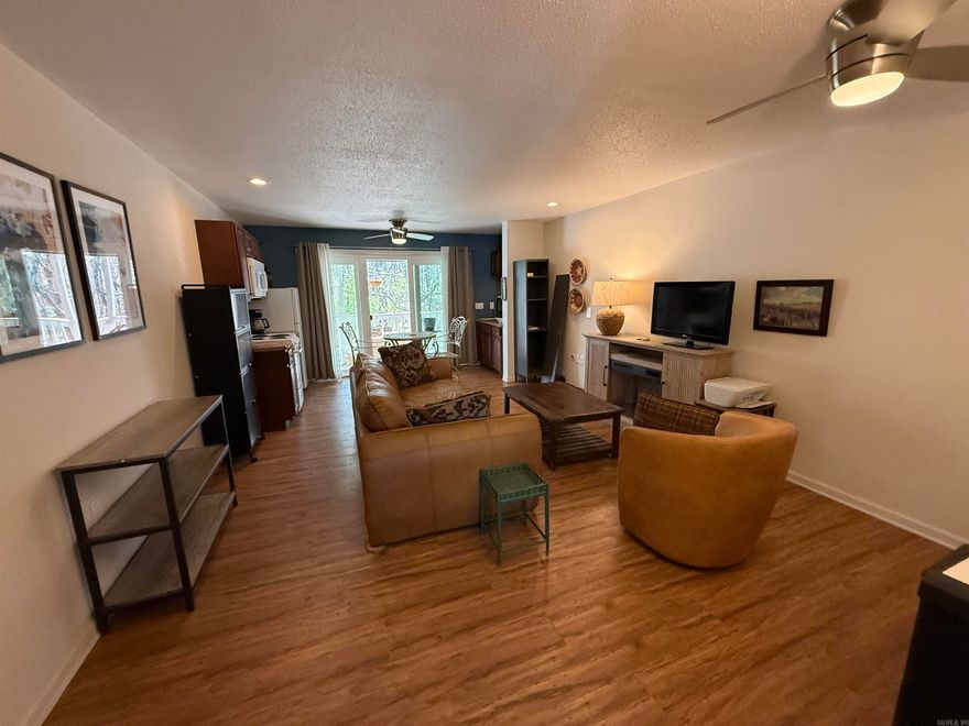 UNIQUE & UPDATED FEATURES just might be what you need!!!  Nice studio efficiency unit was updated in 2024 and 2025.  Walk-in shower, bathroom fixtures and water-proof tile floor, double-pane sliing glass door system (very energy efficient!), painted accent wall & backsplash electric fireplace/heater cabinet, portable washer/dryer unit, counter top dishwasher, new kitchen storage unit & locker.  Can be purchased with negotiable furnished or unfurnished.  Enjoy the peaceful setting, and access to the Resort amenities such as pools, parks, golf course, minigolf, tennis & pickleball, bowling alley, and ATV/UTV, and hiking trails!!!