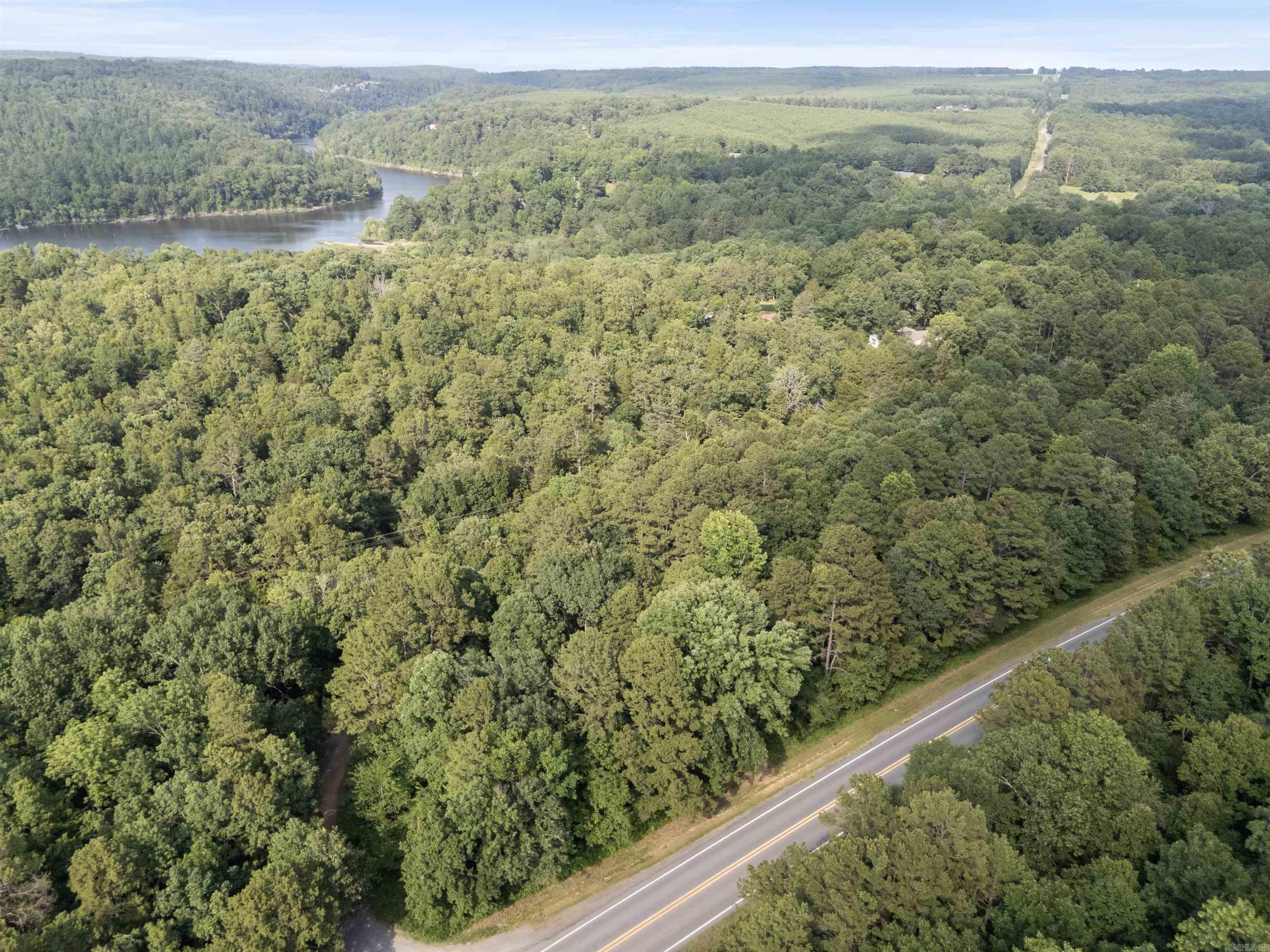 Explore this beautiful one-acre wooded lot in Romance, AR, near Lake Barnett. Perfect for those seeking a rural retreat, the land is sloped and unimproved, ideal for building a dream home or a mobile home. Utilities are available nearby but not yet on the property, and a perc test is required for septic. With immediate possession available at closing, this property offers an excellent opportunity to create your own private oasis in a serene and natural setting. OWNER FINANCING ACCEPTED WITH $2,000 DOWN TODAY! Don't miss this affordable opportunity to own a piece of picturesque land in Romance!