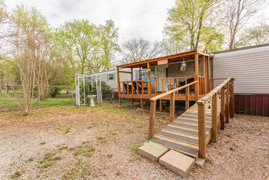 Country home in town on Approx. 1 Acre in Ravenden, AR!  Welcome to this well-maintained 3-bedroom, 2-bath manufactured home nestled on multiple lots totaling approximately 1 acre in the heart of Lawrence County. If you’re looking for peaceful surroundings with room to breathe, this one checks the boxes.  Enjoy your mornings or evenings on the inviting covered front deck (8’x16’), complete with a handicap-accessible ramp for easy entry. The home offers a comfortable layout with a spacious living area, open kitchen and dining space, and a private primary suite featuring a relaxing soaking tub.  Outside, you’ll find a partially fenced yard—perfect for pets or a garden—along with a 2-car metal carport and three separate storage buildings, giving you plenty of space for tools, hobbies, or extra storage.  Located just a short drive from public access to the Spring River, this property is ideal for those who love fishing, floating, or simply enjoying the outdoors.  Additional Note: Sale is contingent upon approval by the Probate Court.  If you’ve been searching for an affordable place with a country feel and practical extras, this one is worth a look.