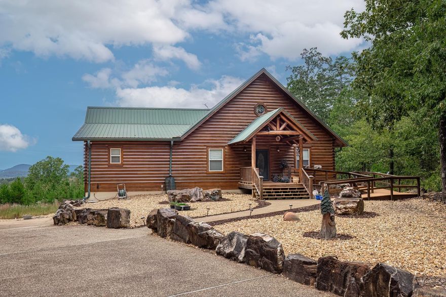 Wonderful community, excellent location, rustic log home. Privacy is the word of the day on this quiet cul de sac. Comfortable living space surrounded by stunning mountain and vista views. Extraordinarily high cathedral ceilings/slate flooring/no carpets anywhere. Very open concept, with a gorgeous, truly, one of a kind stone fireplace. Wall of windows, granite counters, rich wood cabinets, most with pull-outs. Primary bedroom is enormous and secondary bedroom is apart from it with an ensuite full bath. Laundry room with loads of storage. Large 2 car garage and enormous walkout basement. Basement has a half bath and electric outlets galore, well-lit and windowed. Ready and waiting for your imagination. Perfect for anyone looking for a peaceful getaway, this private sanctuary is tucked away from the hustle and bustle of everyday life. Enjoy quiet mornings with coffee on the porch or cozy nights by the fire—this home is all about relaxation and connecting with nature.  Low maintenance yard, too.  Escape to your very own secluded retreat We could go on and on, but you just have to see it.