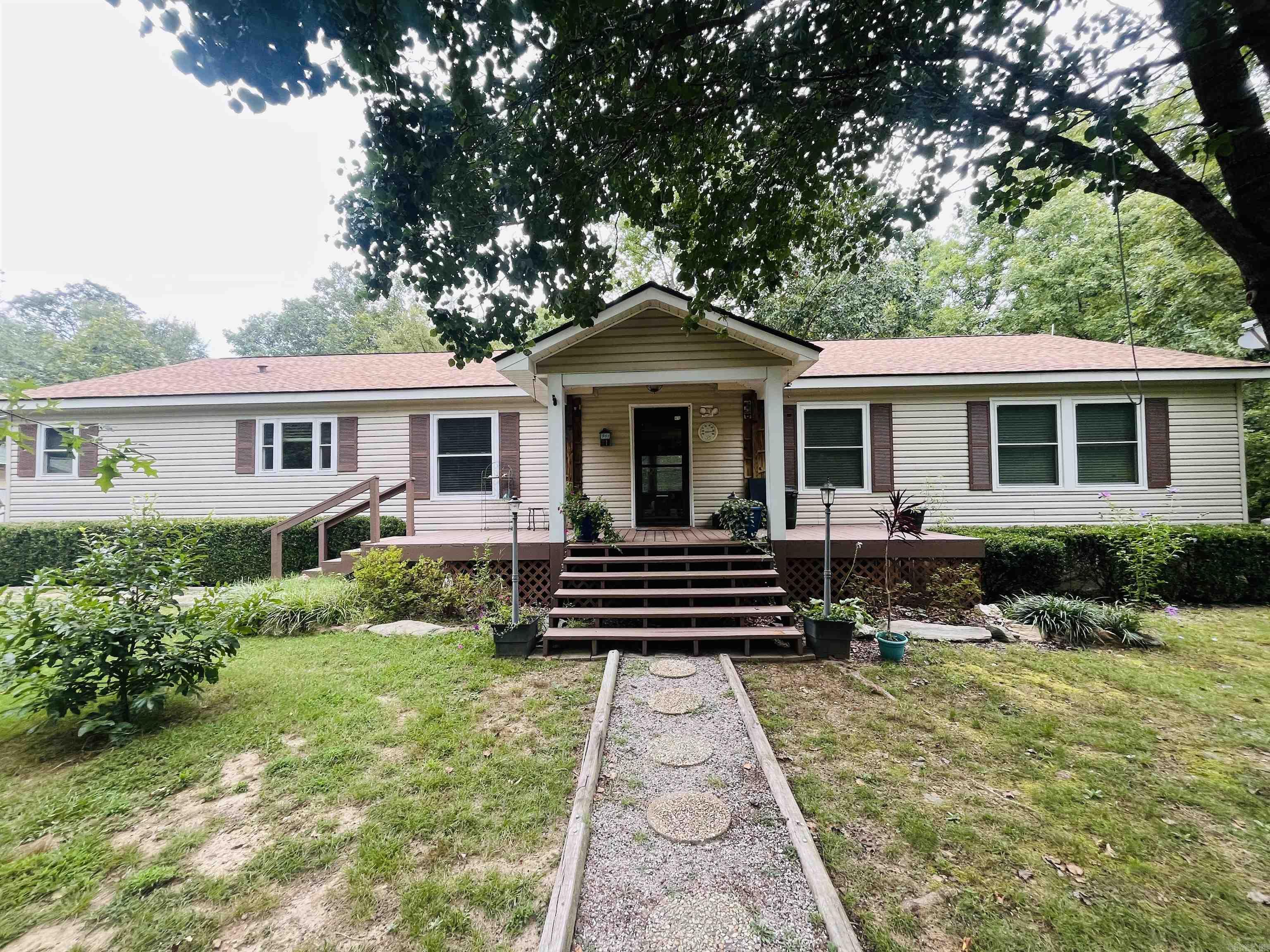 Not One but TWO well maintained doublewide Mobile Homes on almost 7 acres! Perfect for a family compound or live in one and rent the other. All fenced and gated, pond w huge catfish, creek, garden, fruit trees, blueberries, blackberries and muscadines! This property looks like a botanical garden! Both homes are 3 bedroom 2 bath, open concept kitchen/ living area and extra large closets. 2 Huge shops with electricity to store all your toys and several out buildings. Sit on the back porch and listen to the creek and watch all the deer and turkey!