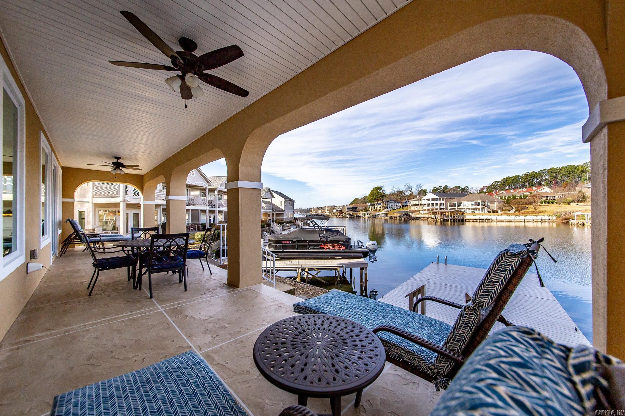 Breathtaking Gated, Lakefront Condo built in 2020, this stunning condo offers modern elegance and scenic views located in the heart of beautiful Lake Hamilton. Just steps away from a private boat slip that conveys with the property, this condo is perfect for lake lovers and outdoor enthusiasts. Professionally decorated and designed with entertaining in mind, the open-concept floor plan flows seamlessly indoors and out, featuring two spacious living areas and covered patios perfect for gatherings. Custom drapes/shades convey. The kitchen boasts a large island, quartz countertops, a wet bar, and ample space for a dining table, making it the centerpiece for family and social activities. Three ensuite bedrooms provide comfort and privacy, while extra storage in the garage adds convenience. Conveniently located minutes from Oaklawn Racing Casino Resort, downtown Hot Springs, restaurants, and family friendly entertainment venues. See agent remarks. On Sentrilock. Six months minimum rental.