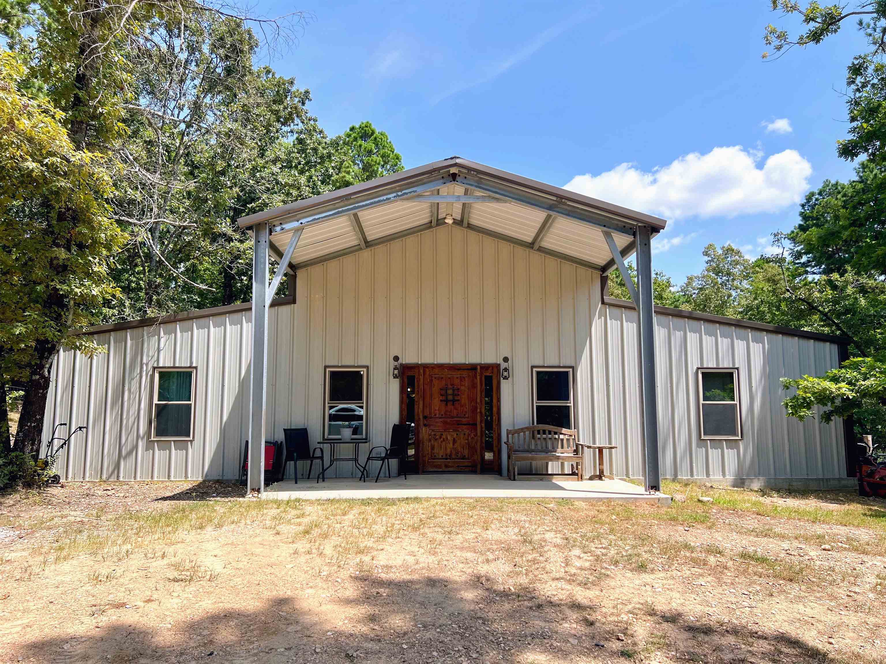Welcome to this handcrafted BARNDOMINIUM sitting on 34 acres with sizable timber, wildlife, and endless charm. This one-of-a-kind property features an open concept living, dining, and kitchen area perfect for entertaining, with a walk-in pantry, an impressive 6-burner gas cooktop with griddle and double oven, and custom handcrafted cabinetry. The interior showcases beautiful woodwork milled from timber harvested right on the property. Featuring a dual fuel heat pump and 6ā spray foam insulation, this home is energy efficient. Enjoy three full master suites, each with walk-in showers and spacious walk-in closets. Additional highlights include a screened-in patio with an outdoor kitchen, a large laundry room, and a fenced backyard. The property also offers a chicken coop, sawmill with shop and a travel trailer with full utility hookups.