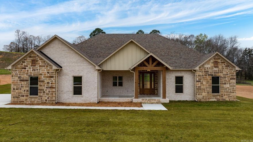 So much curb appeal!! Located on two and a half acres in the Greenbrier School District is this wonderful home with so many extras. Beautiful rock fireplace to match the rock on the exterior of the home.  Abundant cabinetry with a hidden pantry with shelving for all the items that you don't want seen on your countertops. Quartz countertops throughout the home. Enjoy the view from the living room into the private backyard. Fabulous windows at the back of the home let in so much light and show the beautiful view. Coming in from the garage is a half bath with lockers for coats, shoes and bags. You can circle through the laundry room into the primary closet through the bathroom and into the bedroom. You will enjoy the soaking tub and separate shower. By the way, the closet is massive. Very large laundry room with sink and plenty of cabinets. Covered back porch with rock. You will appreciate the storage in this home! Make this home a must see!