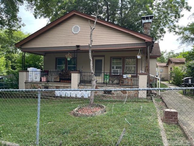 Investors!!! Charming 1940 bungalow on a spacious corner lot featuring durable cinder block and stone construction. This character-filled home boasts original hardwood floors, a cozy stone fireplace, and tasteful updates to the kitchen and bathroom. Enjoy a fully fenced yard, detached shop, and a small studio guest house—perfect for guests, creative space, or additional income. Currently tenant occupied, offering immediate investment potential.