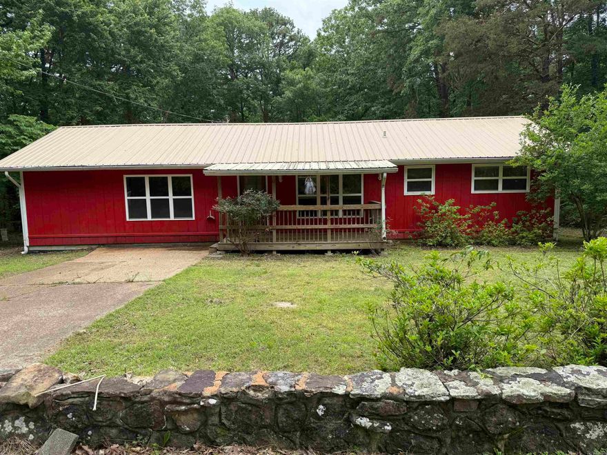 DARLING COTTAGE near the Fairfield Bay Marina on Greers Ferry Lake.  Fantastic Price.  Very recent updates and clean up.  Ready for you to move right in as your residence, vacation home, or to use as a rental.  An addition provides a large Master suite with step-in tiled shower, new fixtures, walk-in closet!!  A minisplit unit was added to the Master in 2024.  An open kitchen, dining, & living areas have vaulted ceilings, & will give you space for family time.  Some custom cabinetry in the kitchen, & stainless/black appliances.  (Stove sold AS IS)  A nice 16x8' covered porch is on the back and overlooks the yard.  Two other BRs with full bath complete the space.  Floors are LVP, tile & carpet.  There's a covered front porch for relaxing.  Metal roof, and the gutters were installed in 2018. In the crawlspace in 2024, 30 floor joists were replaced & dehumidifier and sump pump.  A 10x8' storage building will make a great shop or for yard equipment.   Located just minutes from Greers Ferry Lake and the Fairfield Bay Marina.