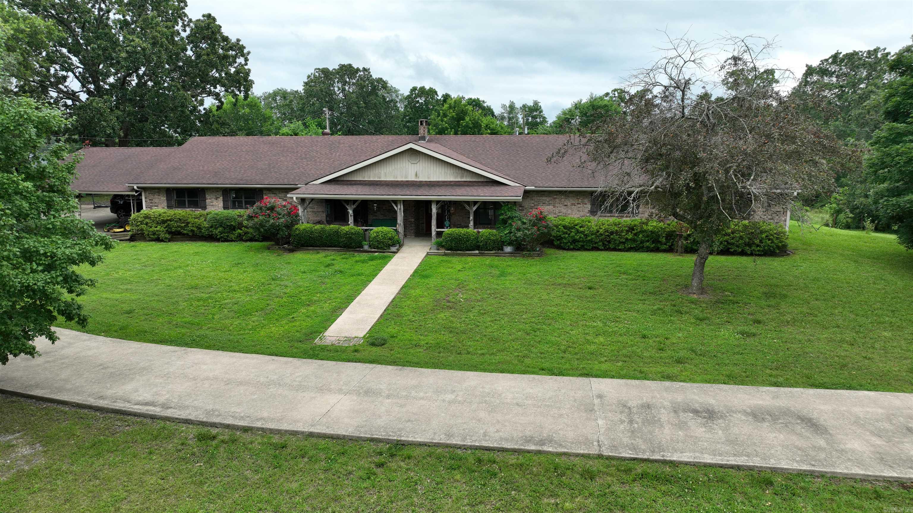 Ranch-style brick home offers 3,722 SQFT of comfortable living space, featuring 4 extra-large bedrooms & 3 full bathrooms. Set on 10 acres just outside of town- near Mena Lake. Fenced & cross-fencedāperfectly suited for livestock, gardening, or smaller scale farming. Outbuildings include 24x30 metal shop w/concrete floor & lean-to & electricity, plus 40x40 barn. 2 ponds (1 wet-weather) enhance the propertyās agricultural & recreational potential. Spacious country eat-in kitchen w/abundant cabinet & counter space, double wall ovens, breakfast bar & a large adjoining sun room/playroom. Primary suite includes walk-in closets, extra storage, & access to the in-ground swimming pool. Hall bath features linen storage & a separate powder room area for added functionality. Additional highlights include a cozy indoor fireplace, backup gas heat, & storm shelter. Oversized attached two-car garage includes 3rd bathroom w/shower, space for extra refrigerators or freezers, built-in storage, plus storage room. 3-vehicle carport. In ground swimming pool and outdoor fireplace offer the perfect setting for relaxing or entertaining in the peaceful countryside. Perfect place for homesteading paradise!