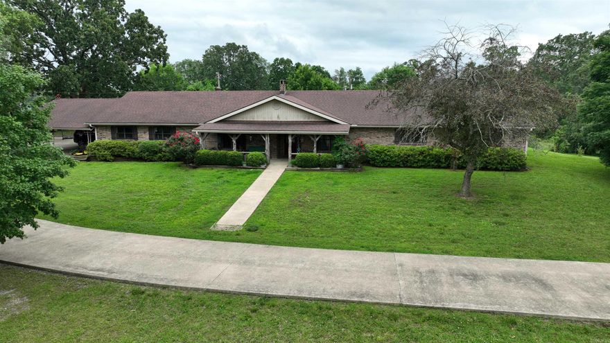 Ranch-style brick home offers 3,722 SQFT of comfortable living space, featuring 4 extra-large bedrooms & 3 full bathrooms. Set on 10 acres just outside of town- near Mena Lake. Fenced & cross-fenced—perfectly suited for livestock, gardening, or smaller scale farming. Outbuildings include 24x30 metal shop w/concrete floor & lean-to & electricity, plus 40x40 barn. 2 ponds (1 wet-weather) enhance the property’s agricultural & recreational potential. Spacious country eat-in kitchen w/abundant cabinet & counter space, double wall ovens, breakfast bar & a large adjoining sun room/playroom. Primary suite includes walk-in closets, extra storage, & access to the in-ground swimming pool. Hall bath features linen storage & a separate powder room area for added functionality. Additional highlights include a cozy indoor fireplace, backup gas heat, & storm shelter. Oversized attached two-car garage includes 3rd bathroom w/shower, space for extra refrigerators or freezers, built-in storage, plus storage room. 3-vehicle carport. In ground swimming pool and outdoor fireplace offer the perfect setting for relaxing or entertaining in the peaceful countryside. Perfect place for homesteading paradise!