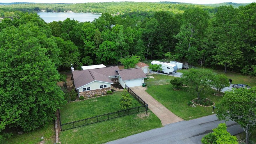 Just around the corner to Crown Lake, this beautifully maintained 2 bed, 2 bath home sits on 1.75acres & offers 2,122 sq ft of bright, inviting living space. Vaulted ceilings, light colored vinyl plank flooring, & soft neutral walls fill the home with natural light, creating an open, airy feel throughout. The cozy gas log fireplace anchors the living space, making it the perfect place to unwind. Step into the sunroom & out onto the concrete patio where you’ll feel tucked into your own private retreat—overlooking a thoughtfully landscaped yard with blooming flowers, strawberry beds, & plenty of space to enjoy. The fenced yard is ideal for pets, gardening, or simply soaking up the peaceful surroundings. The heated & cooled 2-car garage adds year-round versatility, while the walk-out basement—also climate controlled—offers the perfect flex space for a game room, office, or even a 3rd bedroom. Additional features include a storage building with electric, whole-home backup generator, storm/safe room, irrigation system, RV hook up & fiber internet NEXT. If you’ve been looking for light, space, and a relaxed lake lifestyle—this one delivers!