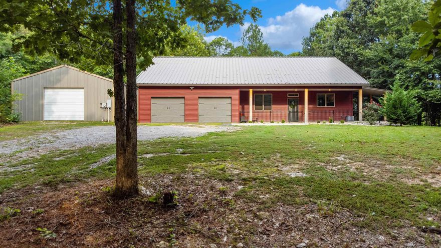 Discover this stunning home tucked away along the peaceful South Fork of the Saline River.  Thoughtfully designed to blend modern comfort with natural beauty, this riverfront property offers a truly one-of-a-kind setting. Perched above the river, the home is solidly constructed with a thick concrete foundation, red iron framework and a durable steel siding - built with longevity in mind. Inside, you will find two spacious bedrooms and bathrooms on the main level, with an additional bedroom and full bath upstairs - perfect for privacy and guests. The oversized main bathroom features separate his-and-hers areas that meet at a shared walk-in shower. Soaring vaulted ceilings and expansive windows flood the open living and dining areas with natural light, while wrap-around porches provide a view of the river. Cozy up by the wood-burning fireplace on cool nights.  A two-car garage, a 30x40 workshop, and an attic offer ample room for vehicles, tools, and recreational gear. This exceptional property is ideal for anyone seeking serenity and functionality. Perfect for enjoying nature and wildlife.