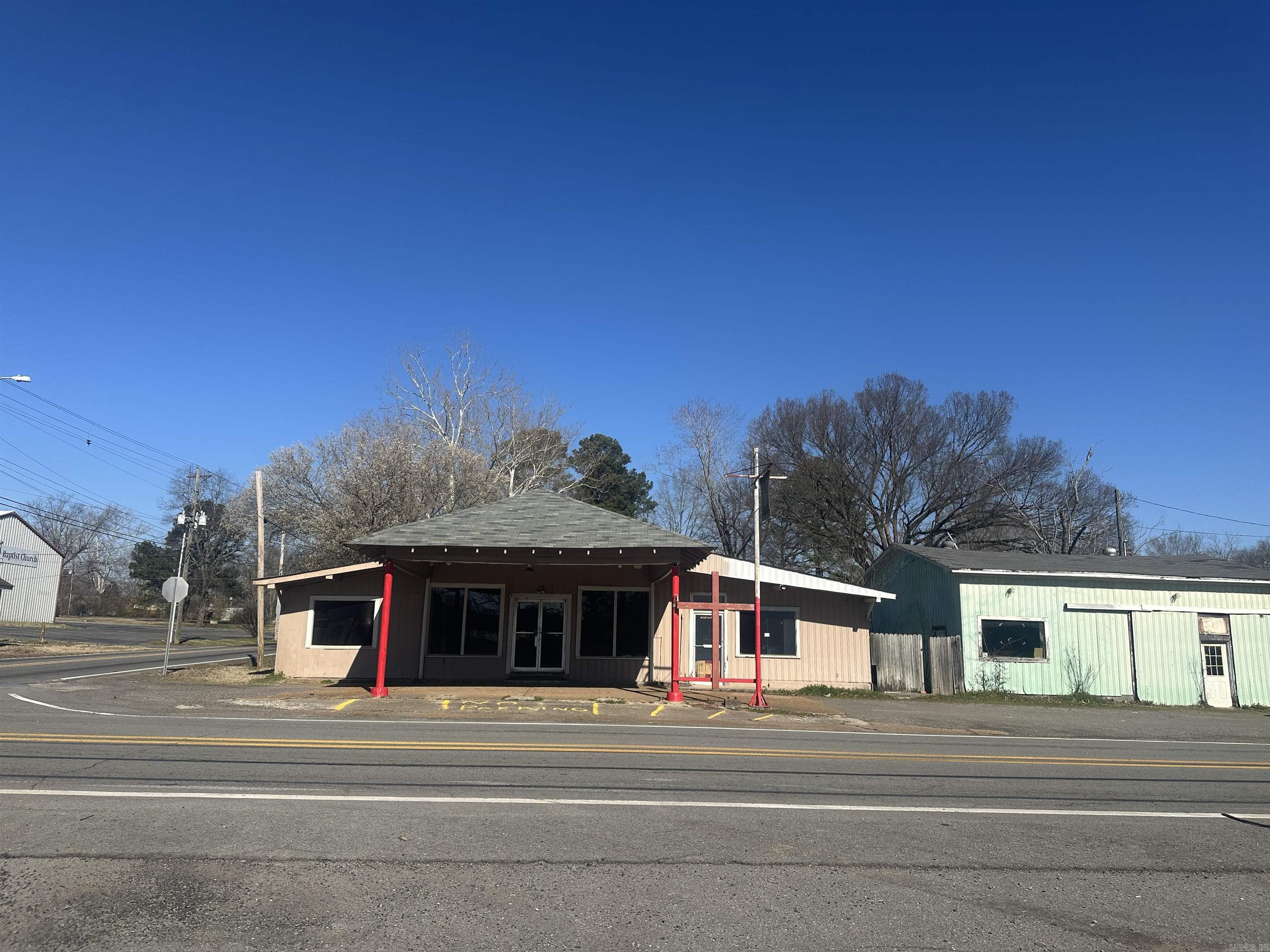 Commercial buildings include a 3564 SF store, attached 1748SF, 3BR/2BA residence, metal 980SF storage with addresses of 102 E 2nd & 104 E 2nd Street. This property to be sold AS IS and all as one sale. This is estate sale with no disclosures. Investment opportunity! ZONED C2 for businesses. Corner of Hwy 367 (2nd street) & Moore St--very heavy traffic count for Ward-main thorough way through town. Survey & legal description on docs on line-property is tract 3. See agent notes.