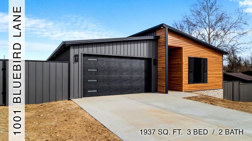 Modern design and low-maintenance design define this newly constructed home with 3 bedrooms and 2 full bathrooms. The exterior features low-maintenance metal siding/roof and sleek double-sided steel panel fence enclosing a large, private yard. Step inside to an expansive living space featuring polished concrete floors, recessed lighting, and tall ceilings. A gas-log fireplace wrapped in polished porcelain serves as a stunning focal point, while oversized windows bring in natural light. Clean lines and modern hollow-core doors carry the contemporary aesthetic throughout the home. The kitchen offers quartz countertops and seamless flow into living/dining areas. The spacious primary suite includes double vanities and custom tile shower with curbless entry. Additional features include a covered back patio, gas tankless water heater, and a 2-car garage. Conveniently located within walking distance or a short drive to restaurants, shopping, and everyday amenities.
