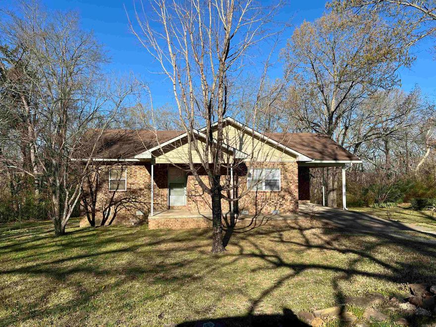 Nice home across from the Fairgrounds and within walking distance of the Folk Center. It features 3 BR/1.5 BA with brick and vinyl exterior on .26 acres. Living area is spacious with hardwood floors, vinyl in the kitchen and bathrooms and carpet in the bedrooms. It's all electric with CH/A, city water and sewer. There's a single carport, laundry room and outdoor storage building. Yard is small and easy to manage. Give us a call!