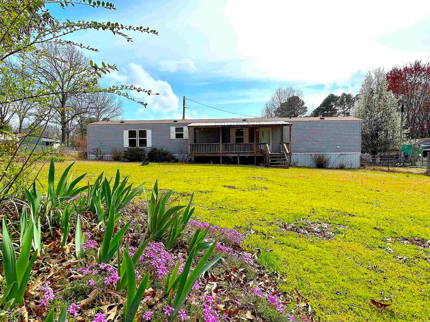 Looking for affordable, comfortable living in a rural setting?   Here is it!   This 2016 home still feels new!  Spacious, open living area with built-in shelving.   The kitchen and dining combo offers a breakfast bar, lots of cabinets and counter top space and a pantry.  The fridge can stay!  The separate laundry room is conveniently located and the washer/dryer remain with the property!   The primary bedroom on suite is spacious and is apart from the other bedrooms - featuring a walk-in closet, large tub, double sinks and walk-in shower.  This property offers lots of improvements - You are sure to enjoy the large, COVERED FRONT PORCH complete with a swing.  TWO STORAGE SHEDS and TWO METAL CARPORTS and an IN-GROUND SHELTER   The property is level and FULLY FENCED expect for the driveway.  What a great place for a garden, pets, pool or your family to play!   You get all this on ALMOST AN ACRE.   Make your appointment today!   See agent remarks.