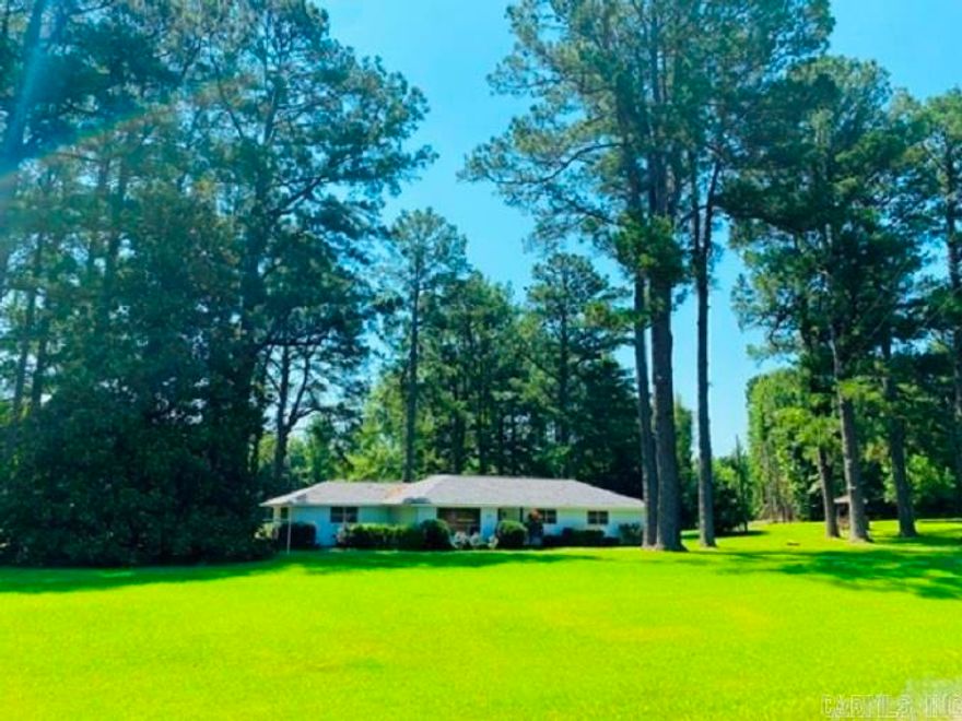 This beautiful home is completely renovated from ceiling to flooring.    Sitting on 11.6 acres, this 2 bedroom, 2 bath ranch style home is move in ready.  The yard is stunning with large shade trees, magnolia tree and an inviting driveway that leads to a covered garage and patio at the back of the home.  There is a 28' x 32' storage building/shop  New Roof 2022, New light fixtures and Security System