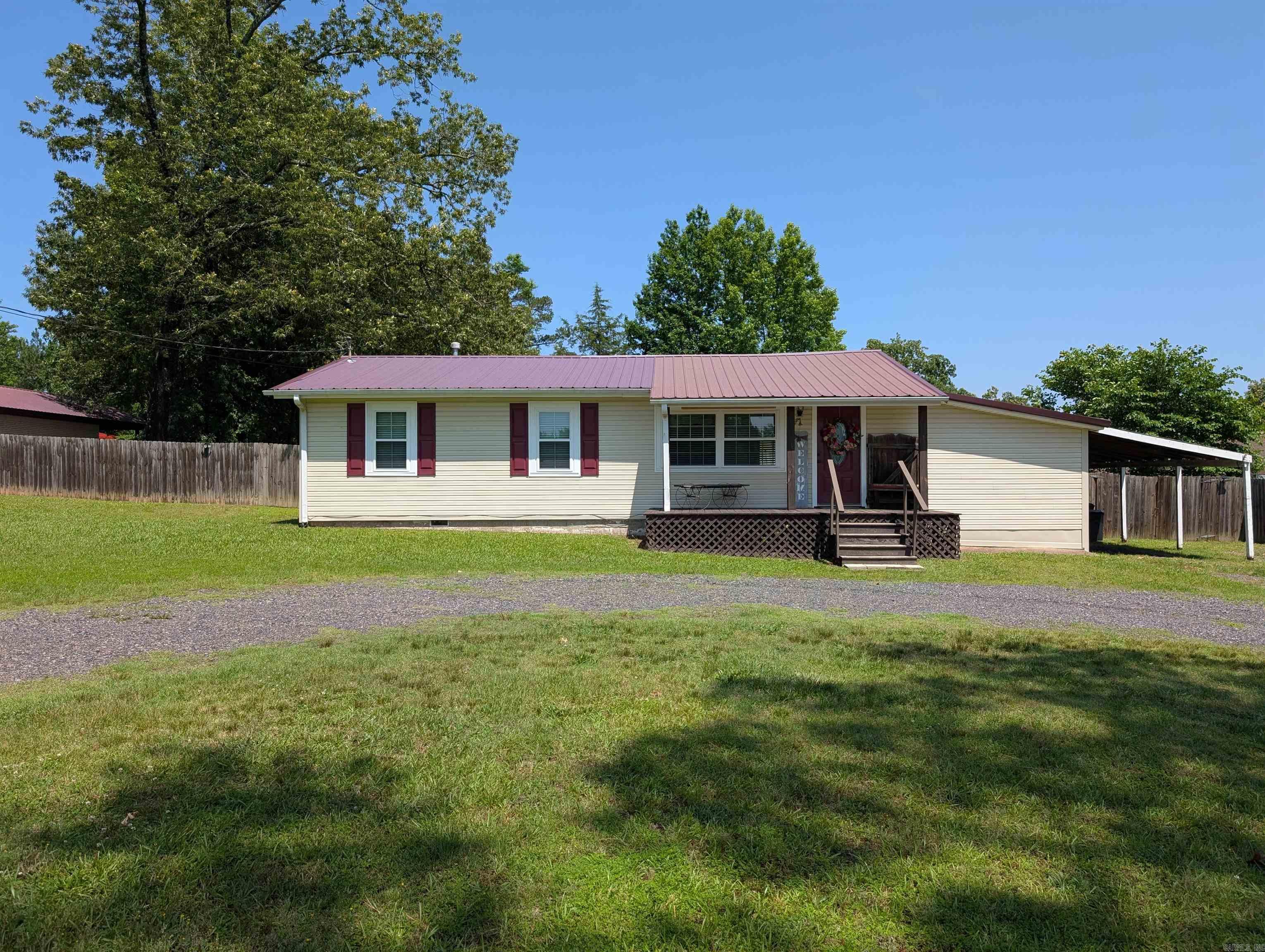 $11,000 PRICE REDUCTION!!! Charming home located at the edge of Mena's city limits. This 3-bedroom home sits on half an acre and features a storm shelter, a new storage building, new windows, new shutters, and a spacious fenced yard. Inside, you'll discover new flooring in the downstairs room, a custom-built kitchen island, and many other upgrades! The property also boasts a large concrete back patio, a one-car carport, and a new gate. This home is ready for you to move in and make it your own!