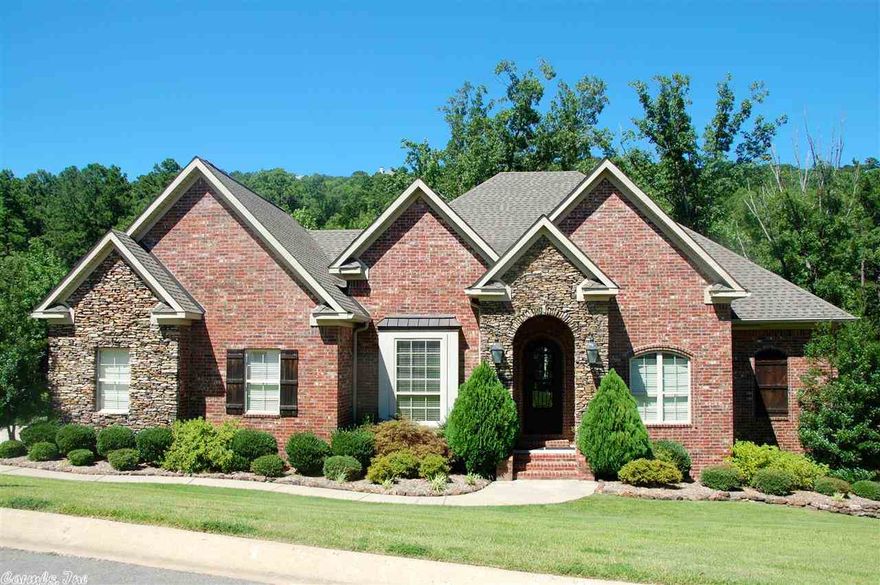 Gorgeous views of the trees!!Wood floors grace the foyer, Living Room & Formal Dining room.  5th bdrm/office and master on main level.  Tile floors, granite counters, double ss ovens, mounted micro, gas Viking cooktop,  3 pantrys, island in large open Kitchen.  HUGE master w/ wood floors, sep his/hers walk in closets.  Second living area, wet bar, 3 bdrms, full bath down.  Opens to lower level deck with hot tub!  MASSIVE backyard looks out on wooded land & makes backyard very private!!