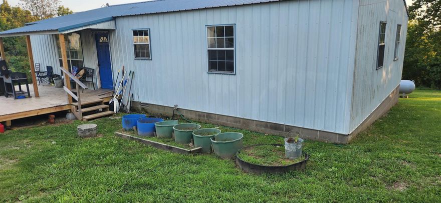 Residential Home AND Commercial Buildings. Flexible live-work-invest INCOME POTENTIAL! Prime mixed-use property. Home: 1288 sqft, 2 bedrooms, 1.5 baths, metal roof, back porch with view - Ideal for on-site living, rental income, or office conversion. Commercial Buildings: 6168 sqft, main 100'x54' structure with 6'x48' addition for expanded operations, storage, and suitable for retail, service business, workshop, event venue, or multi-use commercial purposes.  Storage unit facility: 2000 sqft, 4 units at 10'x20' each and 3 double units. Key Advantages: High demand due to strong tourist-driven traffic in the Spring River area and local housing needs, high-visibility highway frontage. Possible campground attraction. Outdoor attractions include hiking, fishing, canoeing, kayaking, nearby lakes, and Ozark mountain views. Priced to sell, as it needs some "fixing up". See separate listing for more information on the included commercial buildings. (some wide angle photography used)