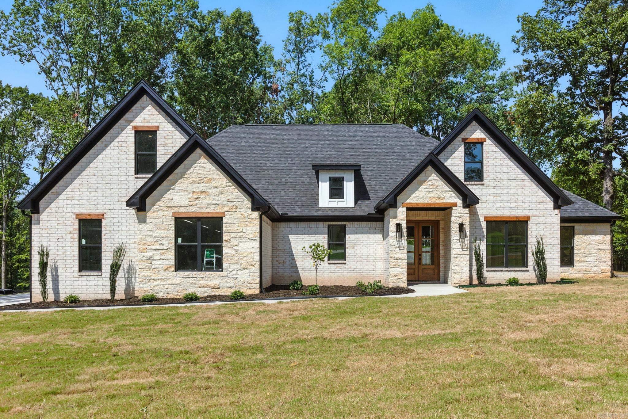 Sitting on over an acre in the gated community of Big Rock Estates, this traditional home offers a quiet country feel minutes from town. Four bedrooms, 2-and-a-half baths, office, and bonus room. No details were spared with natural limestone, brick, cedar accents and tongue & groove ceilings. As you enter the home you are greeted by a home office/craft room/playroom and the fabulous open living space. The kitchen offers a dining/eat-in area, large island featuring quartz counters and bar seating and large hidden pantry providing tons of storage. The primary suite is just off the kitchen which offers tongue and groove ceiling and an on-suite with walk-in glass shower, soaking tub and dual vanities. The walk-in closet offers ample space for all seasons. The secondary bedrooms are split from the master and share a bathroom. The large bonus room can be used as an extra bedroom, media area or entertainment area. The covered patio is a perfect place to relax and offers tongue and groove ceiling, TV outlets and access to propane for all your cooking needs. The oversized 3-car garage offers plenty of space for your vehicles as well as your toys and tools.