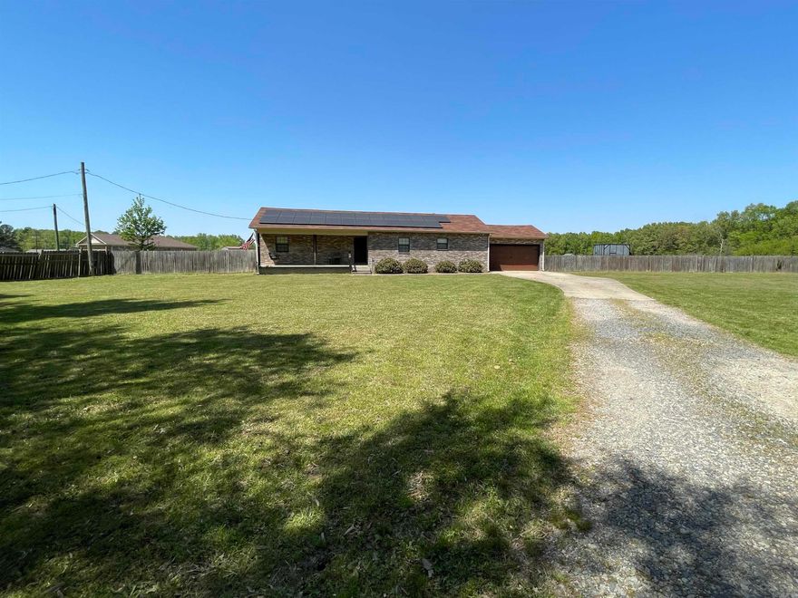 Home is back on market due to buyer becoming ill.  Go and Show! Family home on two acres. New roof 11/2023. Huge privacy fenced back yard with tons of room for kids, pets, gardening, etc. Large kitchen with beautiful granite counter tops and tile backsplash, huge island with extra seating and tons of prep space for the cook in the family. Kitchen/dining space perfect for entertaining and family gatherings. Laundry has matching granite countertops and lots of storage. Granite counter tops continue in the primary and second full baths along with a oversized shower. Relax in the primary bath soaking tub, organize all of your things in the HUGE primary closet, have your morning coffee on the very large back deck, read a book on the front porch swing, or curl up in the family room for a movie. This home has a large front yard along with the massive back yard. New vinyl flooring has just been installed! Home is all electric and has solar panels. The solar panels would need to be assumed by the new owner. Payment is $275 per month until paid off.  There is no gas to the property, all electric, like having a levelized bill for the entire home. Info available.