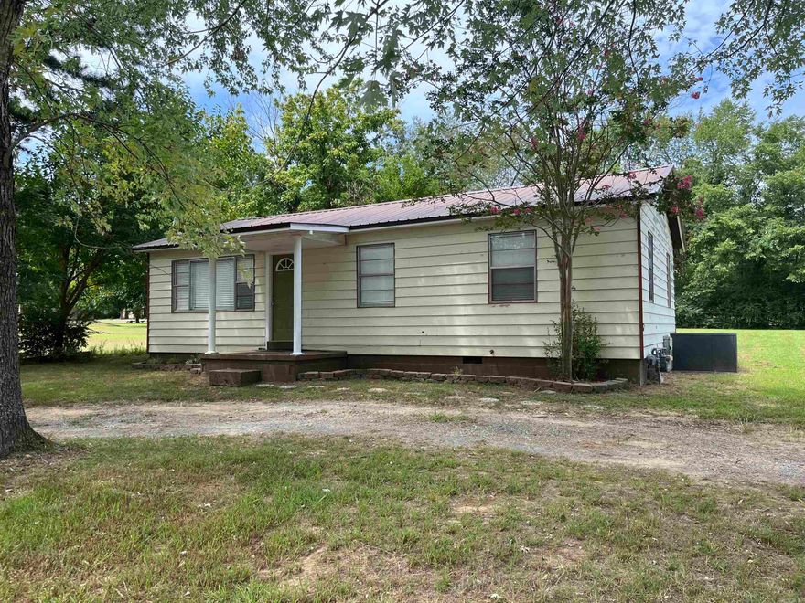 Discover the charm of this cozy 3-bedroom, 1-bath home situated on a spacious 1/2 acre corner lot, just moments away from Southside School. Ideal for those who value both convenience and tranquility, this property offers ample space for outdoor activities and future projects complete with large lofted outbuilding. Enjoy the ease of having daily essentials close by, with a Dollar General, a donut shop, and a coffee shop within easy reach. This home provides a perfect blend of comfort and accessibility, making it an excellent choice for anyone looking to balance the peacefulness of country living with the convenience of nearby amenities.