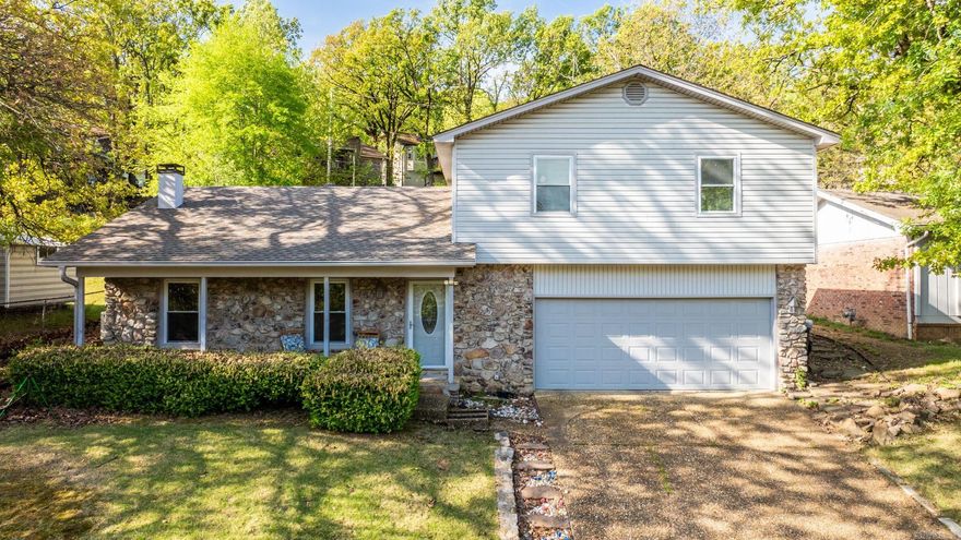 Remodeled West Little Rock home with numerous recent updates including new carpet, new vinyl flooring, fresh interior paint, painted cabinets, and updated interior outlets. Vaulted great room features rock fireplace (decorative only), built-ins, and flat screen TV that conveys. Kitchen overlooks living area and offers freshly painted cabinets, stainless appliances including refrigerator, and dining space. Three bedrooms upstairs all have new carpet. One bedroom includes an updated private bath with shower and single vanity. Two additional bedrooms share an updated hall bath. Covered back deck has been refinished and overlooks backyard. Additional features include full house generator (2018), approximately 13-year-old HVAC, two-car garage with newer insulated door, and washer/dryer that convey. Seller is leaving window unit in upstairs bedroom for extra cooling. Convenient location near shopping and restaurants. Come see!