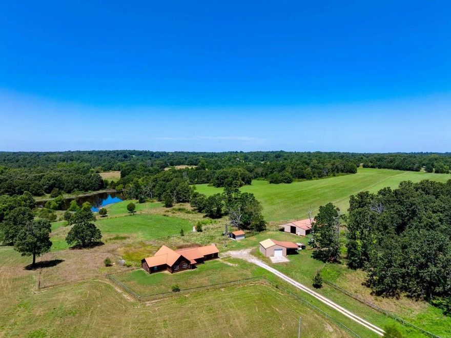 Legacy Ranch Estate offers 117± acres of gorgeous, full-scale agricultural and cattle-ready land, featuring plush fenced and cross-fenced pastures, beautiful pond, and a 4,560-sq-ft custom log home with 4 bedrooms and 3.5 baths. Secluded, scenic, and built for true self-sufficiency, this property includes a hay barn, shop, chicken house, stalls, and all the working-ranch infrastructure needed to support serious farming, livestock operations, and year-round recreation — a rare Arkansas estate that blends seclusion, scenic beauty and self sustaining property.