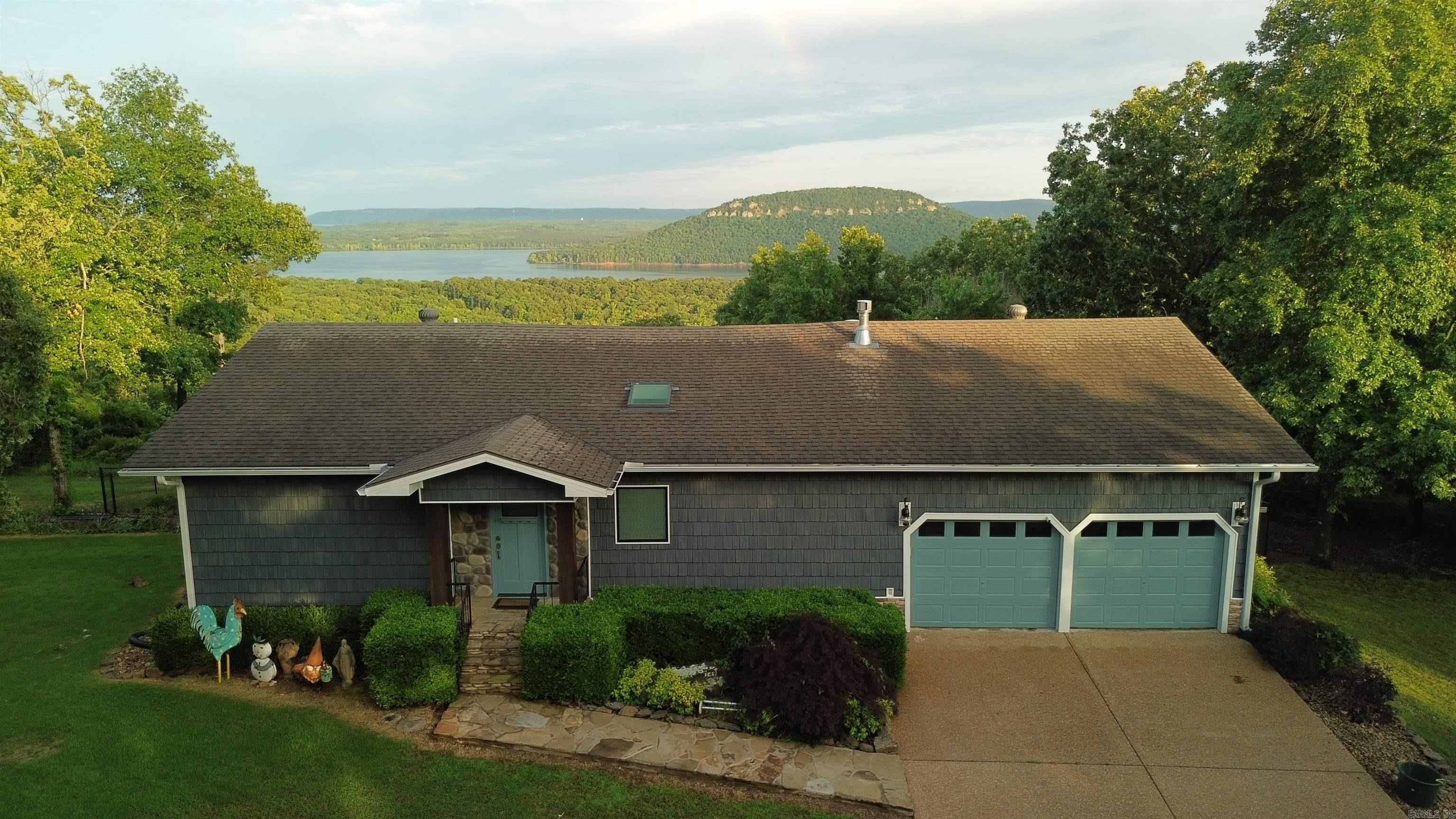 OPEN HOUSE MEMORIAL DAY WEEKEND!!! SUNDAY 2-4pm Experience luxury living in this beautifully remodeled Lakeview home, where no detail has been overlooked. Pella windows showcase the breathtaking views of Greers Ferry Lake and Sugarloaf Mtn. Situated on 5 lots, this property ensures control over your stunning surroundings. Energy efficiency meets modern innovation with solar panels and a geothermal system, keeping bills remarkably low. A dramatic wall of windows spans both levels, flooding the home with natural light and maximizing views, while premium finishes throughout elevate the space to unparalleled sophistication. Don't miss the chance to own this exquisite hilltop retreat! Boat and Lift in boat slip convey at no value. Agents see remarks.