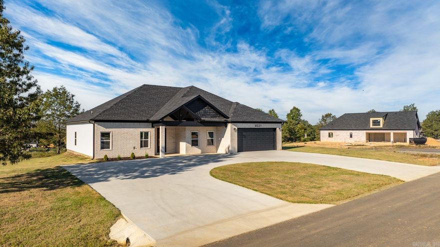 Welcome to this stunning new construction home nestled in the serene surroundings of rural countryside.This modern and stylish residence offers a perfect blend of comfort, convenience, and natural beauty. The house features an open-concept design with high ceilings, natural light to flood the living spaces, creating a warm and inviting atmosphere. Electric fireplace for those cold winter nights, nice kitchen with granite countertops with a good work flow. Four bedroom, two and one half bathrooms, walk in shower, good closet size, vinyl plank flooring throughout. Large two car garage. Nice size back yard for entertaining guests, having cookouts, gardening or just relaxing. Great neighborhood! Move in Ready at an excellent price! Don't miss this one! Bauxite Schools!