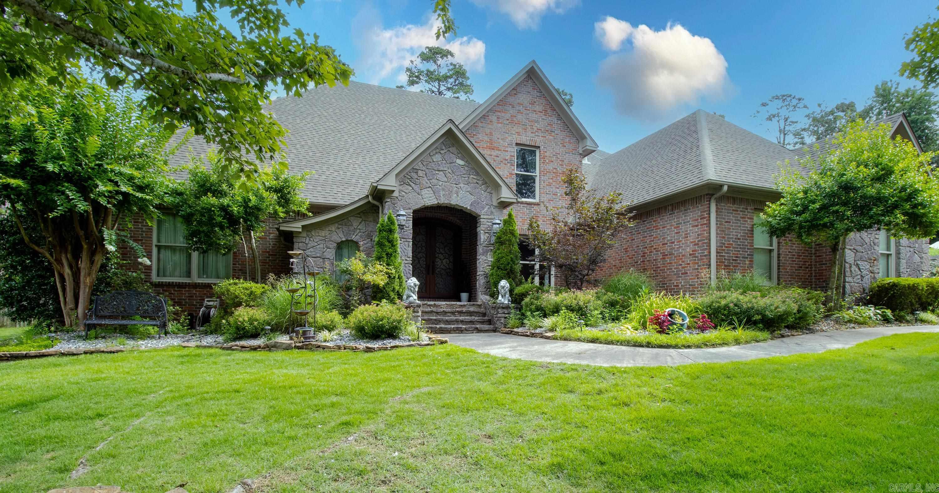 Experience luxury living nestled in an established Chenal Valley neighborhood. This beautiful brick home exudes charm and elegance from the moment you step through the grand iron doors. The kitchen is equipped with new appliances, island, double ovens, gas cooktop and boasts the perfect space to indulge your culinary passions and create memorable entertaining experiences. The owner's retreat is on the main level offering privacy and seclusion from the rest of the home; additional rooms are generously sized. One guest bedroom is down 2 others are up. Great floor plan with 2 living areas down and bonus room up. The seller added a covered and screened in patio that is equally impressive providing the perfect backdrop for entertaining or enjoying peaceful moments. Half acre, fenced in back yard backs to green space and is very private. In ground sprinkler system.