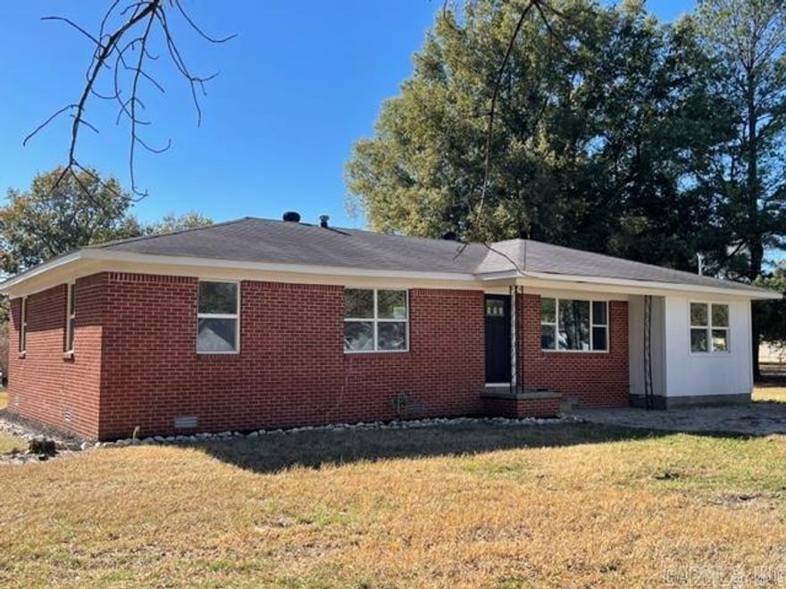 This brick 4 bedroom, 2 bath home is located in Hoxie, AR and has been remodeled inside. This in town home for sale has a spacious open floor plan between the kitchen and living room. The updated kitchen new cabinets, granite top, lazy Susan lower cabinets, stainless steel refrigerator and stove (oven not fully operational). Off of the kitchen is a 12’ x 12’ deck leading out to the back yard. A large picture window lets light into the living room. The main bedroom in the house is spacious & has an attached full bath, it also has small deck leading out for private entrance.  The remaining 3 bedrooms are decent size, each with a closet and natural light. The 2nd bathroom is conveniently located just off the 3 bedrooms. The laundry room with washer/dryer hookups is off of the kitchen.This home sits on a level, corner lot with a few shade trees along the edges of the property.  The easily maintained yard is the perfect oasis to cook out or let kids play. This home is just minutes from Walnut Ridge, AR which has numerous shops, restaurants, doctors and a small hospital. It is also close to some of the best attractions in Walnut Ridge, such as the Beatles Park, the Wings of Honor Museum