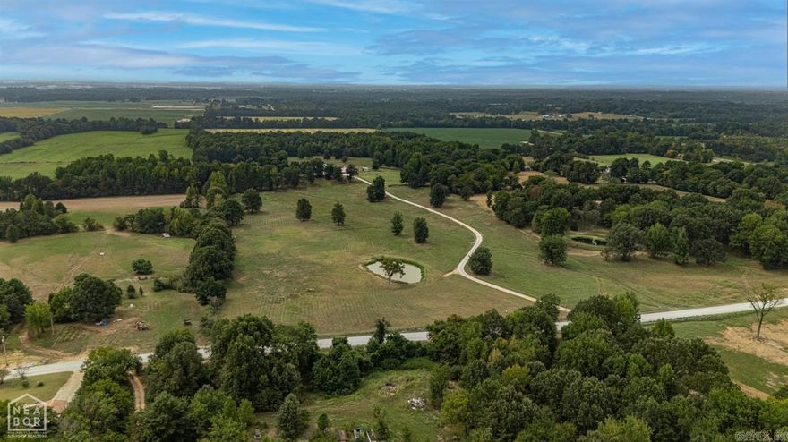 This one-of-a-kind, 4bedroom, 3.5bath, ranch style homes rests on a quiet and stunning 47-acre tract. Located just 5 miles North Paragould, this oasis is the perfect place for your horses and cattle to roam. A ball watering system is located in pastured areas. The property is fully fenced, surrounded by a tree line that only the biggest of deer like to run. 5 individual horse stalls are attached to the home by way of the 30x60 barn/shop area. A sunflower field, hay barn, tack room, storage area, storage room, covered parking, riding area, large chicken coop, make this unique property truly a site to see. The master bedroom, another bedroom, office, large laundry room, and 2.5 bathrooms are on the main level. Upstairs you will find 2 large bedrooms, a full bathroom, and a large additional living area. Rustic metal ceilings, wood accents, stainless steel appliances, epoxy countertops, pantry, ample storage, and a design that is truly breathtaking. A must see for anyone with equine/cattle or a love for the outdoors.