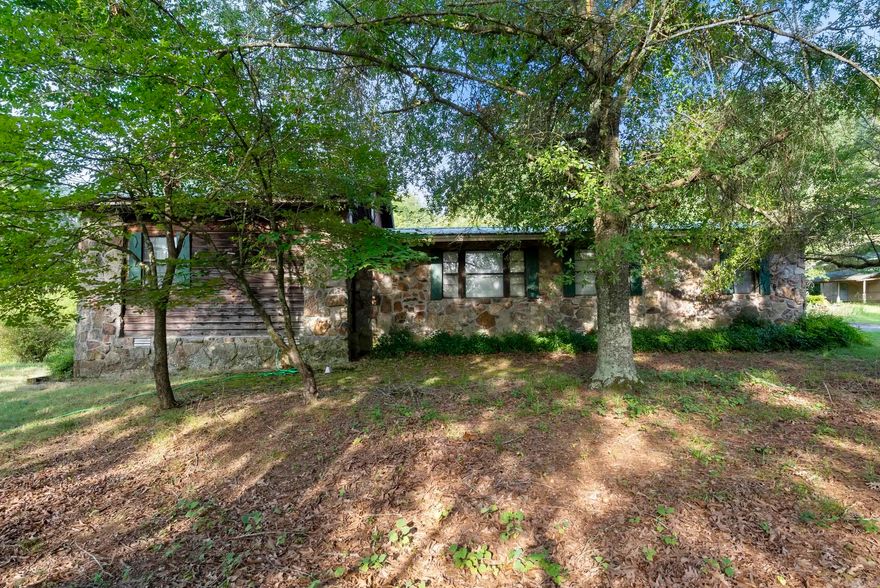 This property was purchased as land investment only.  The house has potential but requires much work therefore is being sold As Is. Included is a large, sturdy covered garage and outbuilding(s). Beautiful large lot hard to find in a very desirable area.  This is wonderful building potential! Call for your appointment today!  Mineral rights convey!  Square footage approximate, please measure.