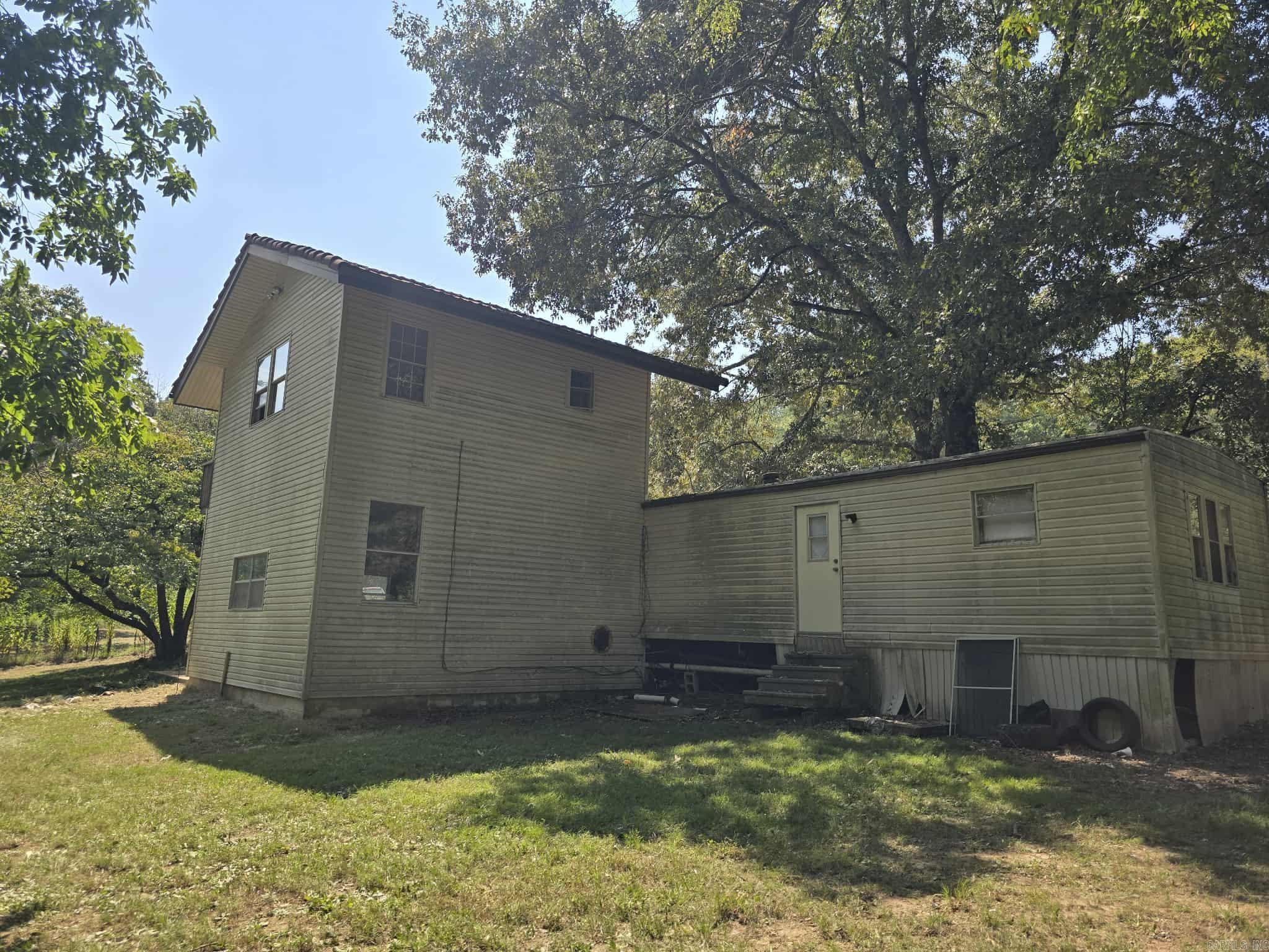 3 bed / 2 bath approximately 1,600 sq ft home on 2 acres m/l in LHSD for only $77,500! The land is extremely nice. Off of Sunshine rd, borders hundreds of acres of National Forest on two sides, dead end road, and only a few minutes from Lake Ouachita. The dwelling isa single wide mobile home with a 2-story addition added on to it. It needs a lot of work and is not livable in its current condition. Completely remodel it or tear down and build your forever home. It would be hard to find better land and location than this! Owner is a licensed real estate agent in the state of Arkansas