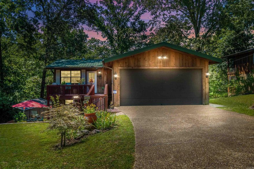 WELCOME TO YOUR LAKESIDE DREAM!  This stunning two-story home on Lake Hamilton offers the perfect blend of peaceful living and income producing short-term rental. Upstairs features open floor plan, large stone fireplace, vaulted cedar ceiling, spacious master suite, with en suite bath, modern kitchen, large combination laundry/pantry room, and a wrap around covered outdoor seating area with gorgeous lake views. Downstairs offers private entrance with second living space, second master suite with large en suite bathroom, large guest room, bunk-room, Kitchen/Living combo and guest bathroom making it ideal for guests or continued use as a successful short-term rental.  Enjoy relaxing evenings by the campfire at the water’s edge or unwind in the Jacuzzi tub inside or the hot tub in the screened-in porch. The covered boat slip,  and multiple outdoor seating areas invite you to enjoy lake life to the fullest. Nestled in a quiet, friendly neighborhood within the sought-after Lake Hamilton School District, this property is your perfect personal getaway or income-generating Short Term Rental downstairs!