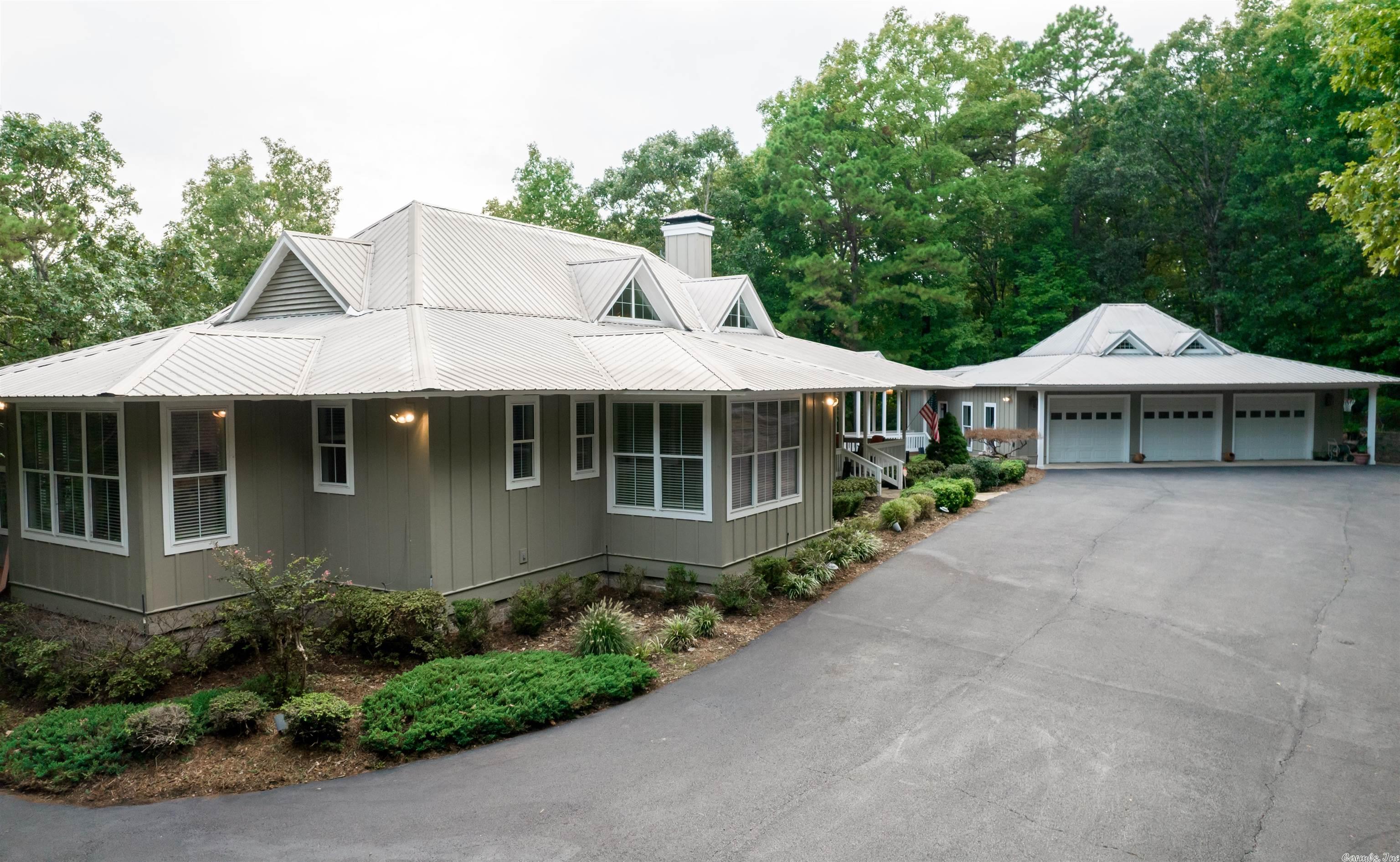This LAKEFRONT HOME on GREERS FERRY LAKE! You will find this gorgeous Southern Living home w/ 3 car garage to offer everything you could possibly want. This home features 2 kitchens, 3 living areas w/ open floor plans on both levels, multiple bedrooms, 2 laundry rms & wrap around deck. Also features beautiful landscaping, water fall, outdoor kitchen, multiple level decks, & easy walk down to the water. If you are looking for privacy, you will find it here! Lakefront living at its finest! Agents see remarks!
