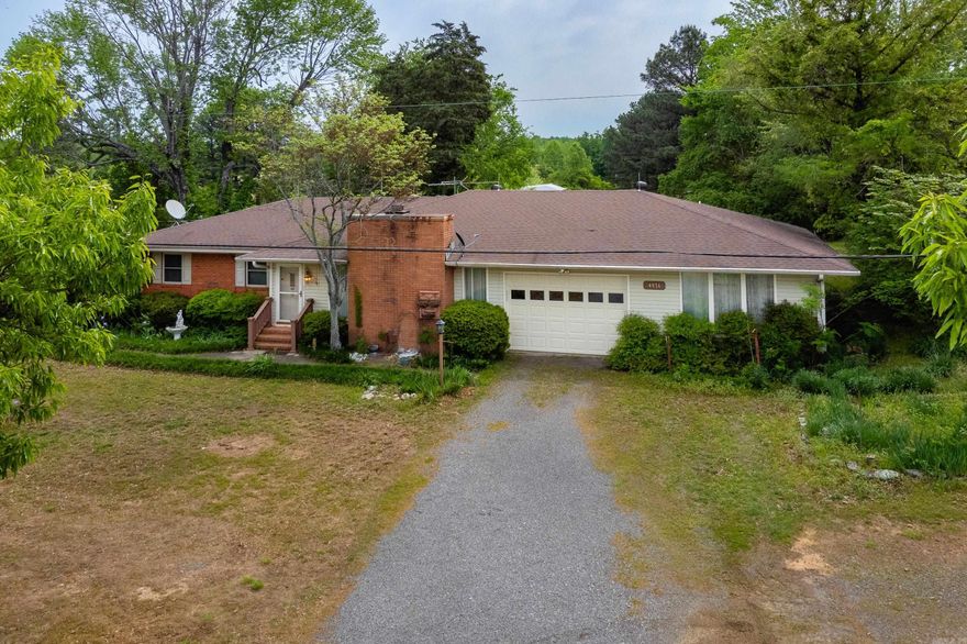 Beautiful family estate where peaceful country living awaits! This 4 bedroom 3 bath home sits on 1.31 acres of land w/open views & endless potential. This home boasts large living area w/fireplace, large dining area w/built in cabinets.  Nice kitchen w/5 gas burner range, microwave & dishwasher. Separate laundry room w/sink & exterior door. The In-law quarters can be entered from the laundry room & also has a separate exterior entrance, new separate Split unit heating & air system, whole house generator, kitchen w/door leading to private deck & full bath. This could be used as Spacious 4th bedroom or another living room. Or this could be used as a bonus room, media room etc.  There is an exterior door off kitchen dining room that leads to screened patio, large storage area & basement.  Gazebo in front yard for entertaining. A sausage making building w/ covered back porch. A huge shop. Another whole house generator that runs home & sausage making building. Beautiful garden areas, RV Shed/Parking, Covered Parking Building. Floored Attic, Attic fan works, 400 ft fresh well, new gas lines to home, Generator runs everything and RV Shed & sausage house. HVAC gas 2015. MUST SEE