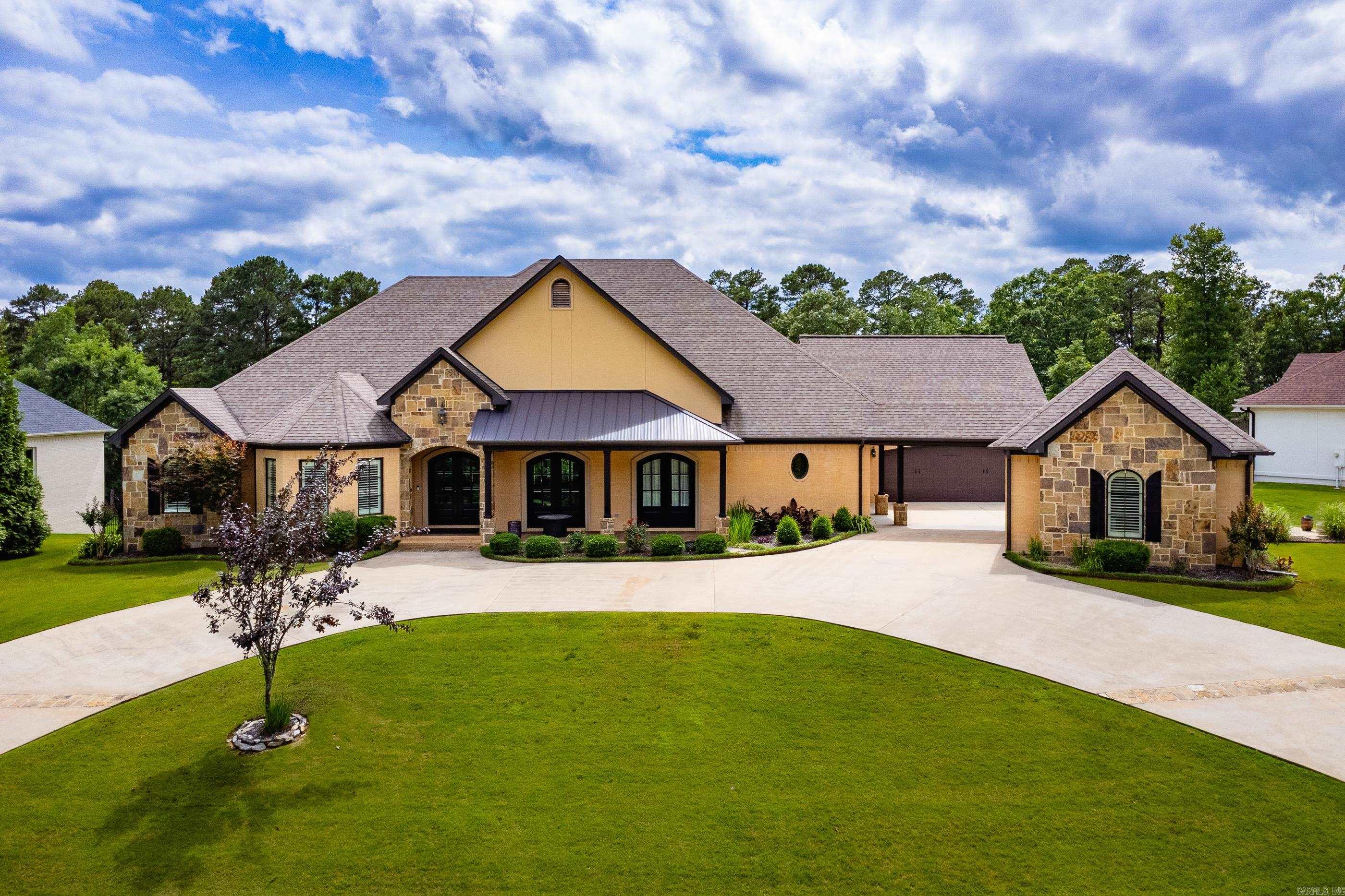 Welcome to 20 Accadia Court, a beautifully updated home nestled on over half an acre in the heart of Chenal Valley. Backing up to peaceful green space, this 4-bedroom, 3.5-bath plus office (or 5th bedroom) estate offers the perfect blend of luxury and privacy. A rare find, it features both an attached 2-car garage and a detached 2-car garage/shopāideal for extra storage, hobbies, or workspace. Inside, enjoy soaring ceilings, brand new tile flooring throughout the main level, fresh carpet in the upstairs bedroom, new custom window shades (app controlled) and new interior paint that gives the home a bright, modern feel. The freshly painted cabinets complement the gourmet kitchen, complete with dual quartz islands and custom lighting. The great room opens to a screened veranda with a fireplace and built-in grillāperfect for entertaining or relaxing. The main-level primary suite includes a spa-like bath, two closets (one is a safe room), and private veranda access. Located in the heart of Chenal, just moments from premier golf, shopping, and dining. Bonus: This home comes equipped with a whole-home generator for peace of mind year-round.