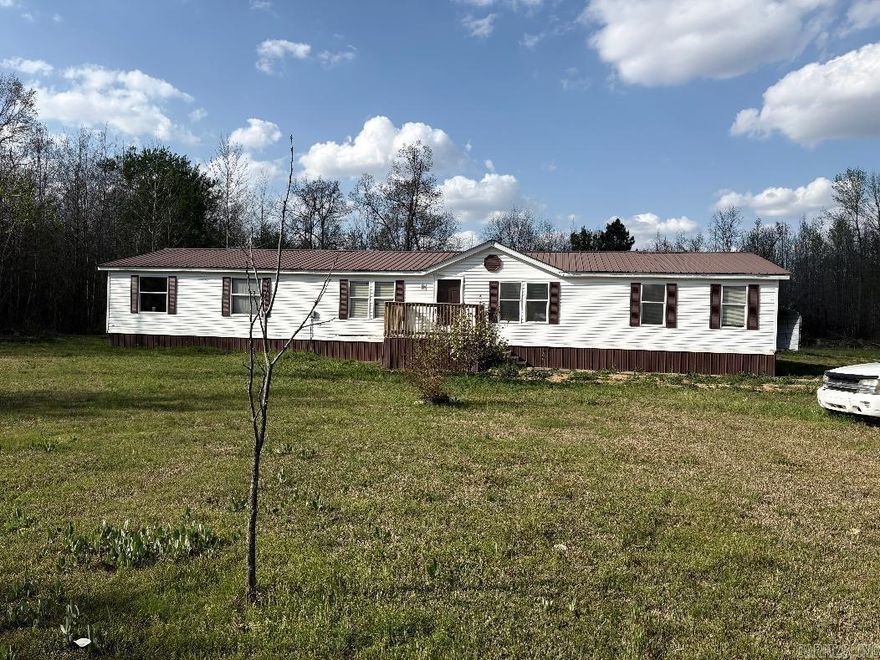 Fully Renovated Double Wide MH (28X80) sitting on 3.03 Acres. It is on Permanent Foundation. Covered Back Porch area and there is also RV Storage Carport and Storm Shelter and RV Hook up in Yard. Home Comes with Refrigerator, Stove and Dishwasher. Seller is leaving a Dining Room table and Chairs and Hutch that will convey. Wood Burning Fireplace in Living Room. Larger Master Bedroom and Large Master Bathroom with Tub and Shower. 0pen Floorplan Living Room and Dining Room has Lots of Space. New Storm Doors will be added to front and back of home. See Agent Remarks!