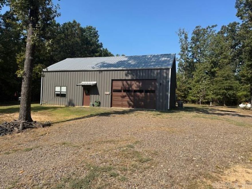 Fully furnished,1200 sf weekend getaway built inside a 30 X 50 shop. 2 stories with approx. 600 sf each, leaving plenty of shop space(30 x 30) fully insulated and finished electrical and plumbing. Too many amenities to list. It sits on an approximate 1 acre lot on Lake Erling. (Some of the best fishing in Arkansas) This cabin is not lakefront but is across the road from the lake and just a few hundred yards from the community's private boat launch. Supplied by its own well (just a couple yrs old), and propane powered emergency generator (same age as well). You would have to search high and low to find a value like this on this lake. Sit out and watch the deer and turkeys in your own yard. This subdivision is just across the street from around 15,000 acres of the Lafayette County wildlife area!!