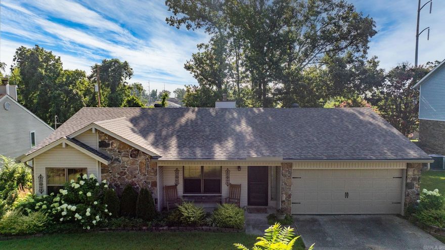 Step inside this beautifully updated 3-bedroom, 2-bath home in the heart of Indian Hills! From the moment you pull up, you’re welcomed by lush landscaping, & a cozy front porch.  Inside, the home is bursting with charm—vaulted ceilings w/ exposed beams, a stunning stone fireplace, & thoughtful details like shiplap walls, board & batten accents, & updated light fixtures. The open-concept layout flows effortlessly from the living room into the dining space and updated kitchen, complete w/ quartz counters, subway tile backsplash, & stainless steel appliances.  The spacious bedrooms offer ample natural light, while both bathrooms feel like something out of a magazine with farmhouse touches, custom mirrors, & stylish lighting.  Out back, your private oasis awaits w/ a fully fenced yard, blooming hydrangeas, a patio for entertaining, & a swing set for the kids. There's also a storage building & a charming porch swing area for those peaceful mornings or evenings under the trees.  This home is a true gem—move-in ready, full of personality, and ideally located near shopping & dining.  New roof, siding, gutters, sliding doors & more. Call me today for a personal showing.