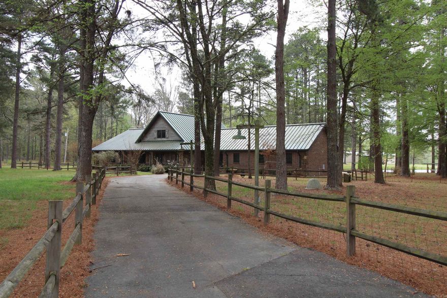 73.01 acres fully fenced*2 stocked ponds*approximately 30 acres in woods with the rest is prime pasture*beautiful unique country home with a combination of brick, rock and D Log cedar*home is built to last a lifetime*ALL steel structure, second floor is concrete and has a standing seam 24 gauge metal roof*three car garage with a drive through portico between the house and garage*full house generator*the ceilings and walls have 3.5 miles of tongue-grove pine!!*8x67 front porch*kitchen has lots of cabinet, two pantries and island*16' vaulted ceiling*massive fireplace with 4' firebox*50x60 barn/shop with all metal structure, 4 stalls, a full bath with mini split, feed room, tack room, overhead doors and an adjoining 60x24 metal lean to*inground 18x36 pool that is 3' deep on one end and 5' on the other*fully automatic powered pool cover-nice!*screened in back porch*gated paved driveway with auto opener*once in a lifetime opportunity*Sheridan Schools*convenient to Little Rock*private!!