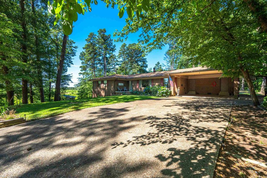 Check out this beautiful in town home with a country feel!  If it's the 4 bedrooms that draw you in or the open floorplan with a wonderful circular fireplace, this is a must see. This has a craft room, laundry room, built in chest of drawers, wonderful garden area with irrigational system, large heated basement for all activities, whether it is exercise or wood working there is plenty of room. House has been updated and in a wonderful neighborhood.  Agents see remarks.