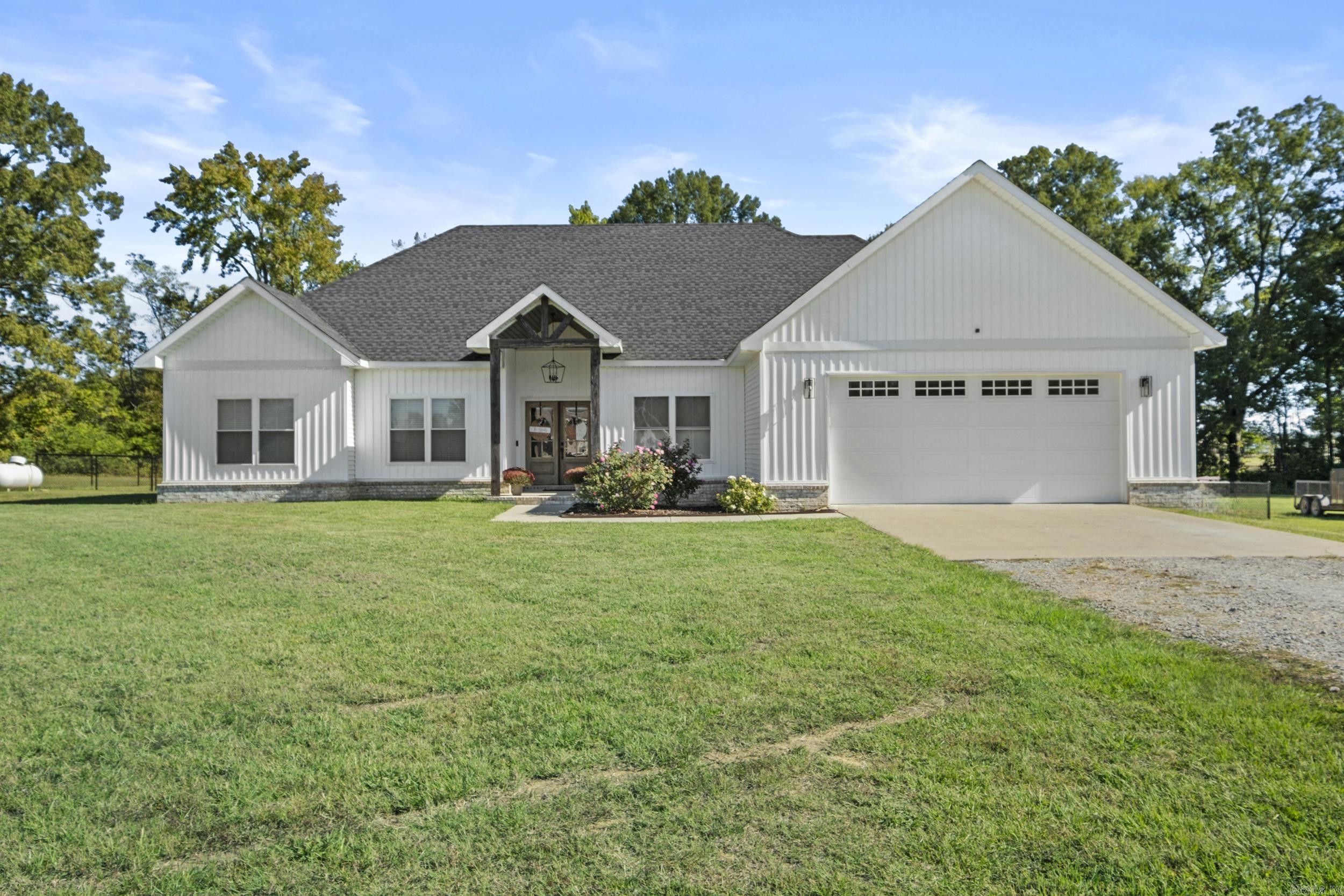 Welcome to this stunning, like-new home built in 2022 that offers the perfect blend of modern, comfort, and country charm. Featuring 4 spacious bedrooms and 2.5 bathrooms, this home provides plenty of room for family and guests. Enjoy open-concept living with stylish finishes throughout. The primary bedroom includes a walk-in closet, access to your back patio space, a double vanity in the master bathroom, with a walk-in shower and soaker tub. Step outside to your covered back patio complete with a cozy outdoor fireplace and 4.0+/- acres of flat, cleared land and a fenced in backyard area that is ready to go! Not to mention it comes with a safe room/storm shelter that is HEATED & COOLED in the garage! Move in ready and meticulously maintained, this home truly has it all! Schedule your showing now, before it's gone.